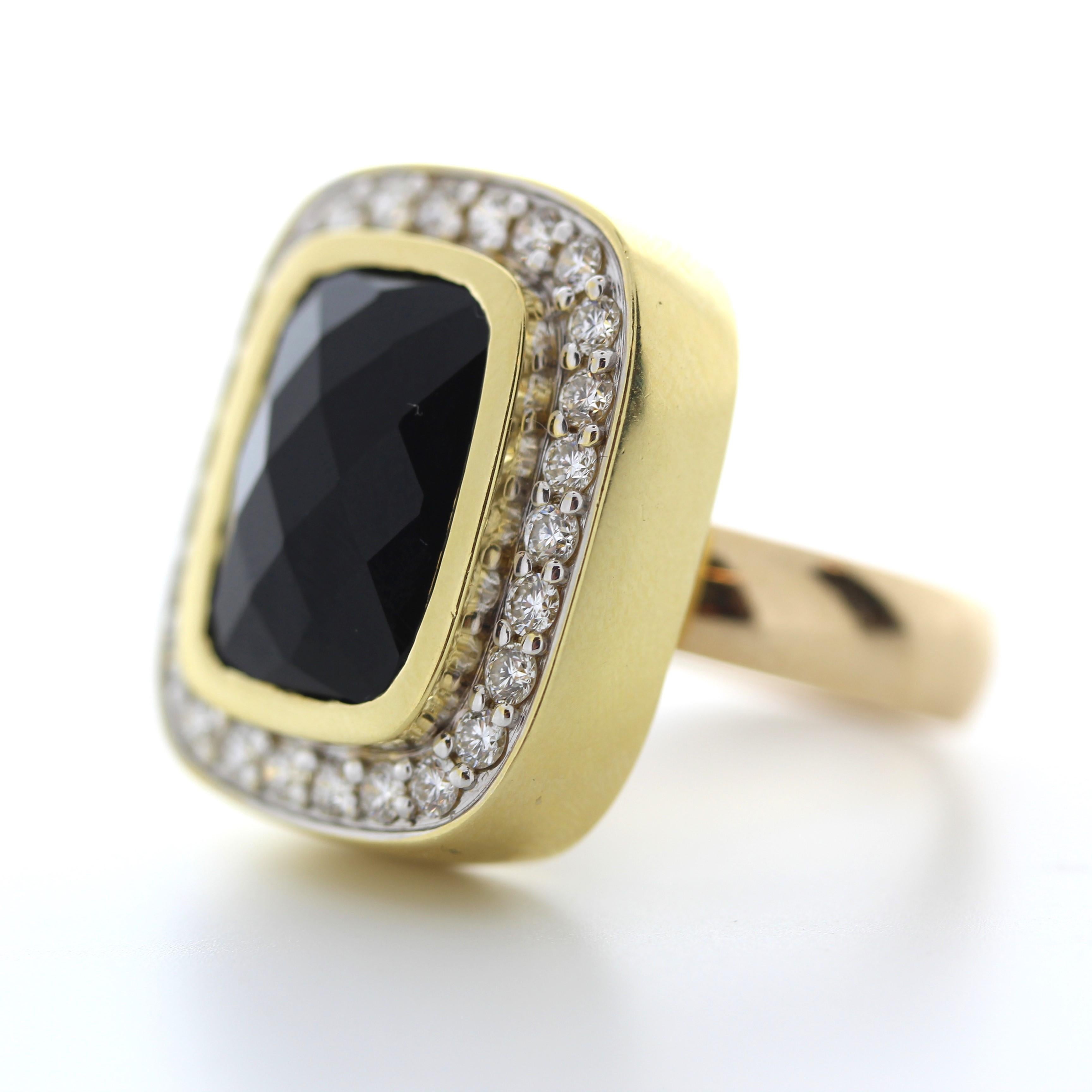 A celebration of a gorgeous shade of black onyx ring in glowing 14K yellow gold and the 1.00 carat total weight of 25 round diamonds that highlight the beauty of the center gem bring you a piece of beauty. A perfect match for elegant evening wear,