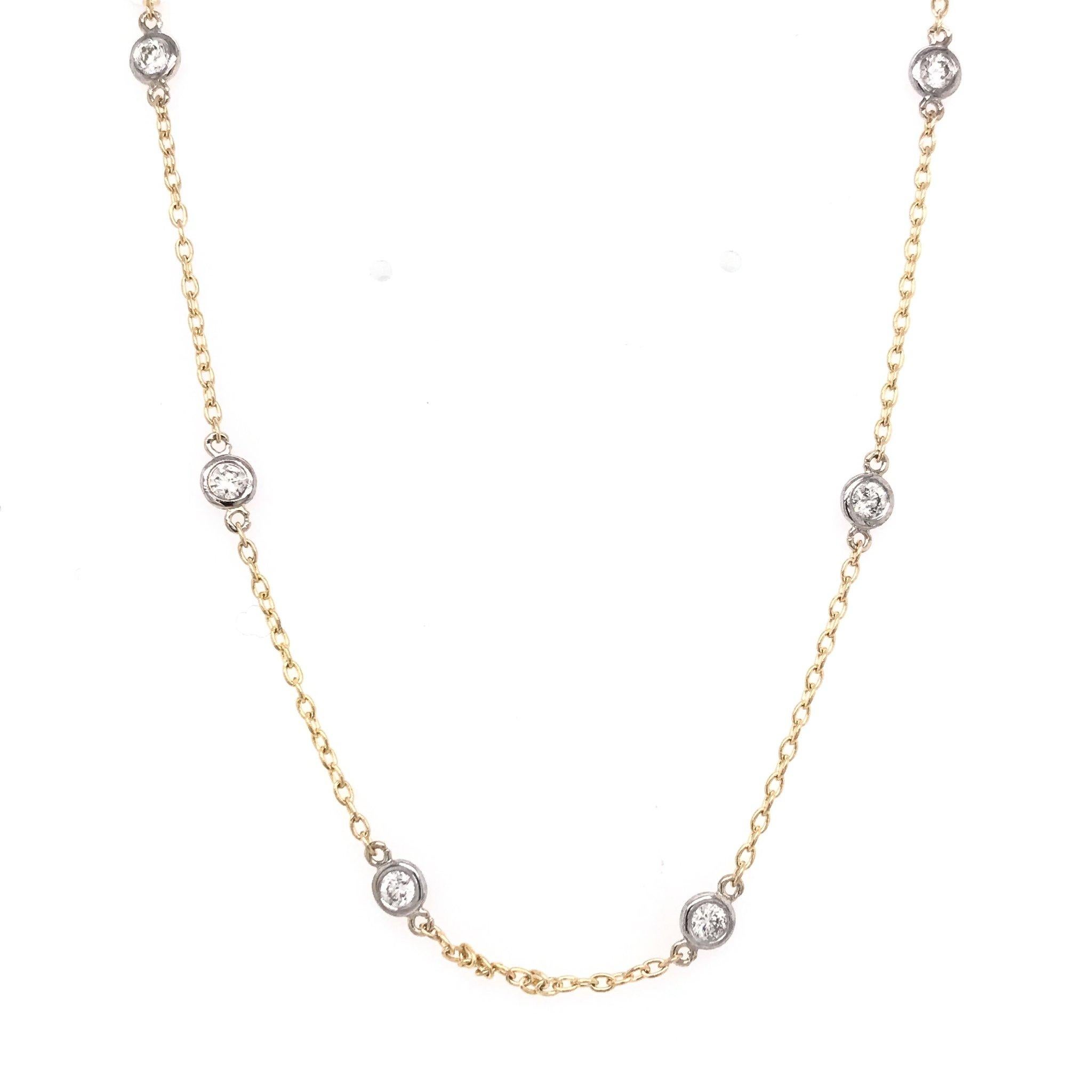 This contemporary piece is new and has never been worn. The chain is 14k yellow gold and features 15 sparkling white diamonds, set in the popular by the yard style. The diamonds are bezel set in 14k white gold and their combined total weight