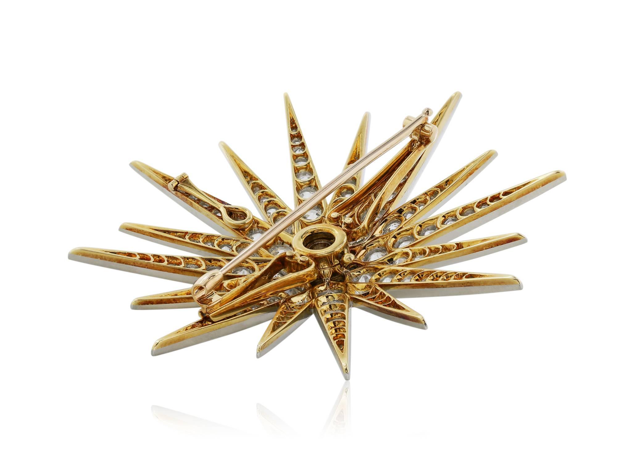Edwardian platinum and 18 karat yellow gold star burst pin/brooch with approximately 10 carats of Old European cut diamonds, including a 1.10 carat diamond in the center, finished with a bail and can be worn as a pendant.