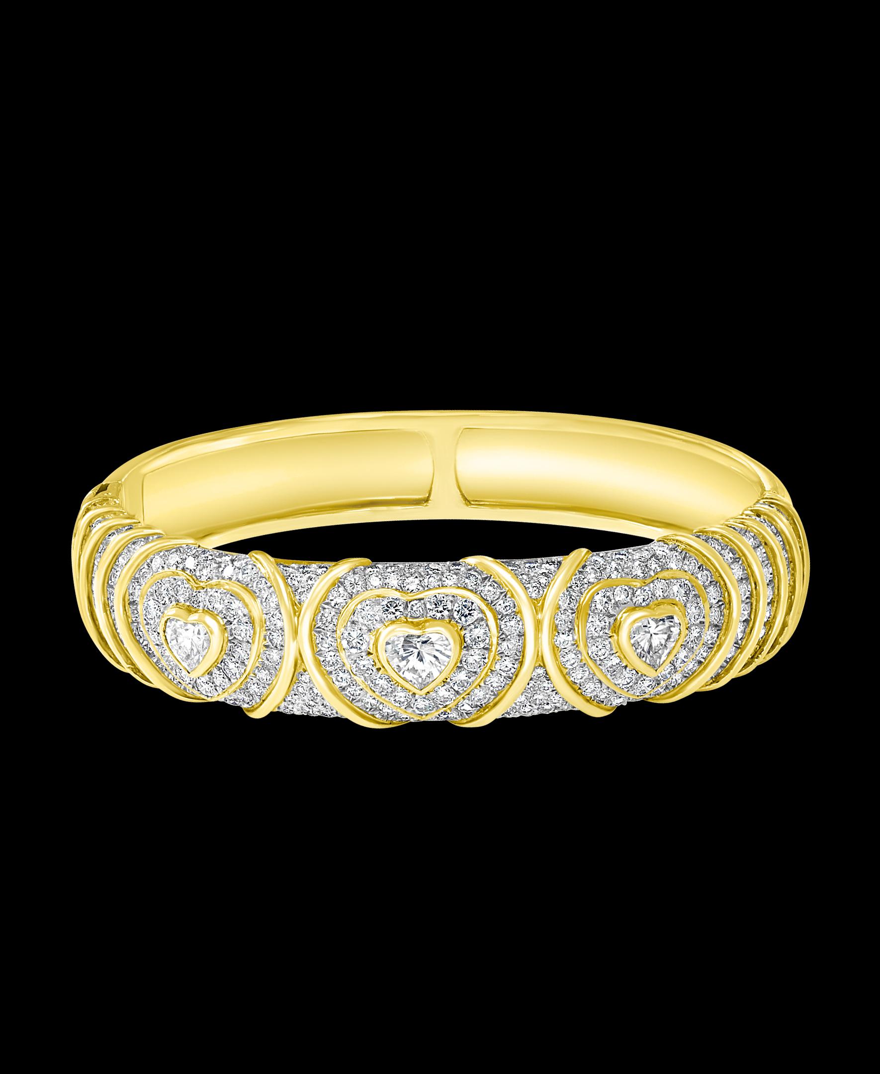 10 Carat Diamond  Heart shape  Bangle /Bracelet In 18 Karat Yellow Gold 48 Grams
It features a bangle style  Bracelet crafted from an 18k Yellow gold and embedded with   3 solitaire heart shape diamonds and  total approximately 10 Carats with  Round