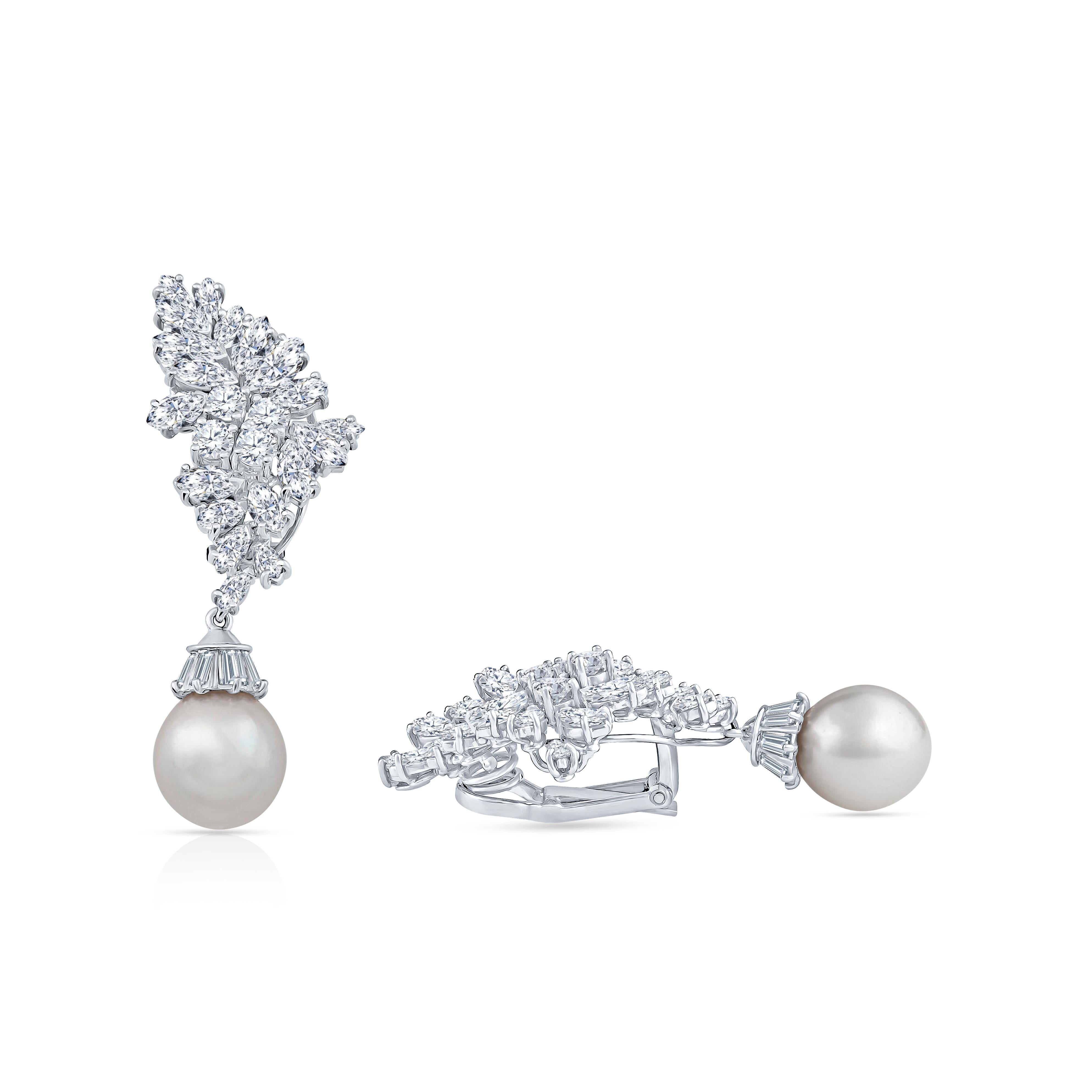 These stunning pearl drop earrings are accented by round brilliant and marquise cut diamonds totaling 10 carats. They are set in 18 karat white gold and feature clip on earring backs. The pearl drop can be removed to wear the diamonds alone.