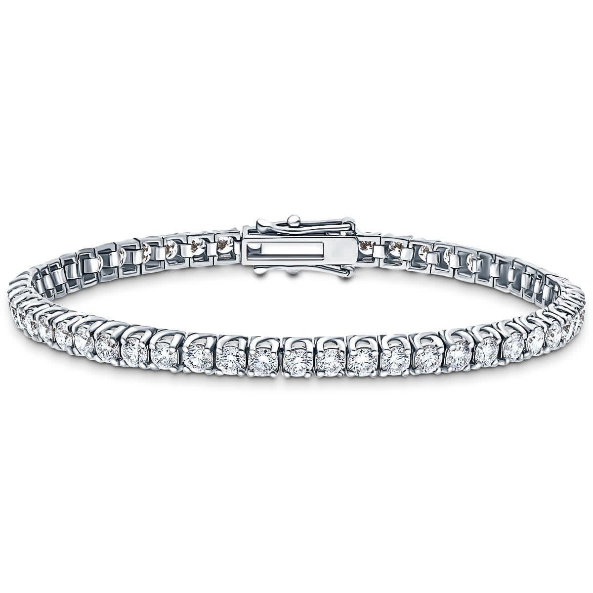 10 Carats of spectacular Round Brilliant Cut Diamonds White Color G / H Clarity SI1 are set in 18 Karat White Gold for this stunning tennis bracelet. Set in a four claw cross over / tulip design with a security clasp. Other carat sizes available