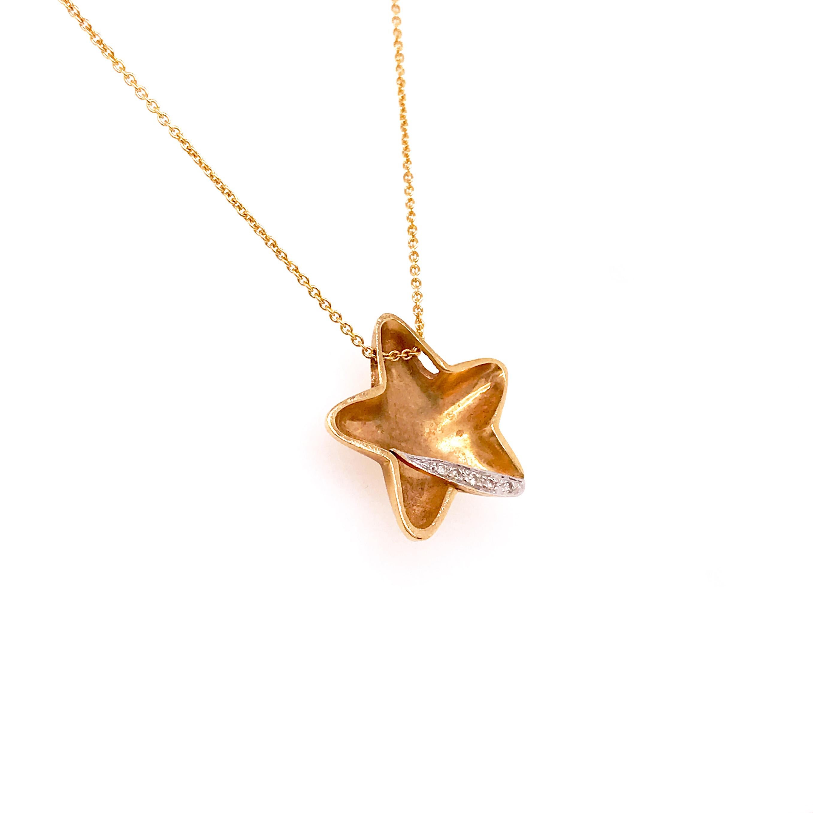 This is a one of a kind designer Pirouettes piece. A yellow gold star charm/pendant with a diamond 
