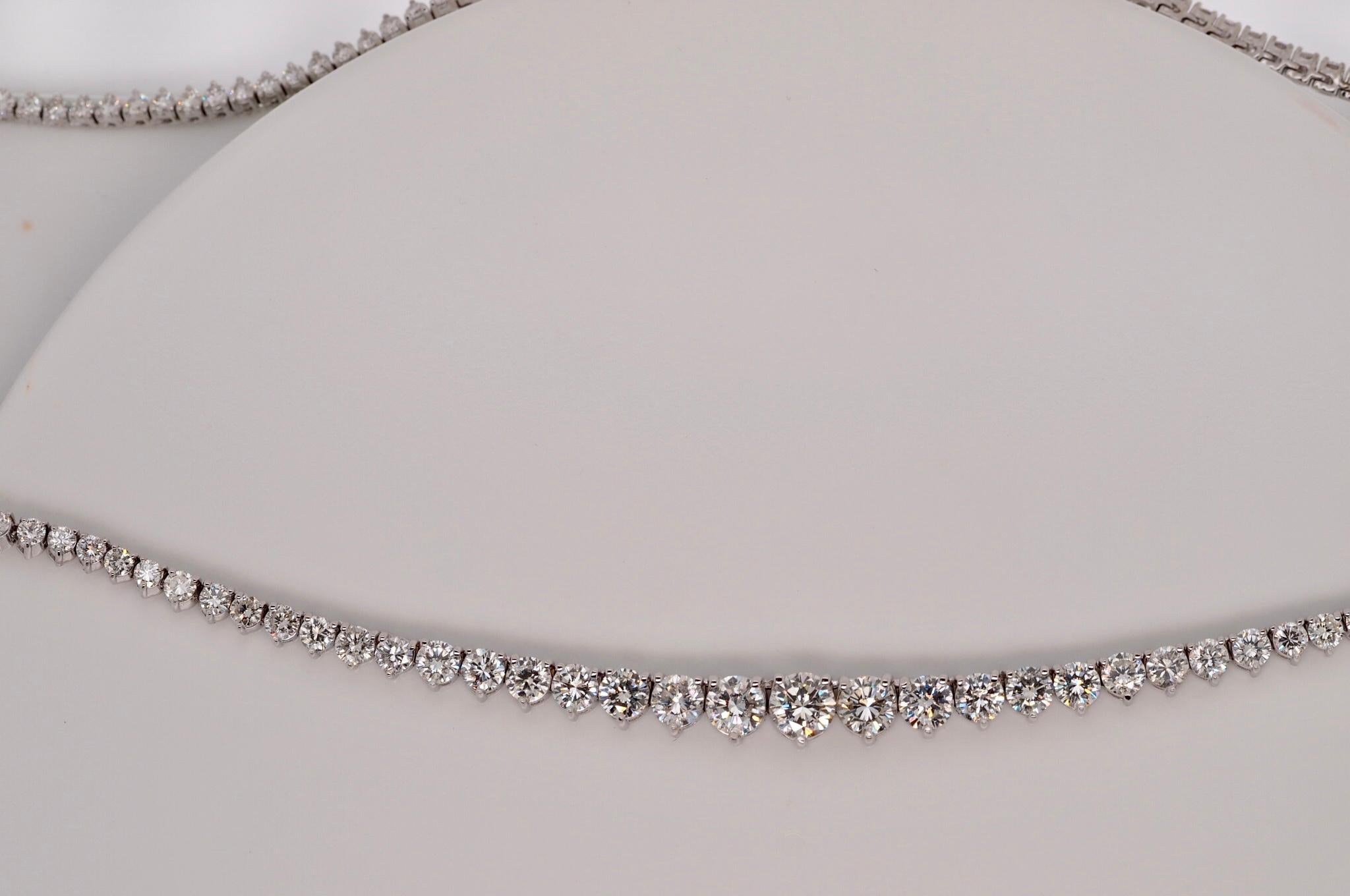 This stunning 14 Karat White Gold Round Brilliant Cut Diamond Tennis Necklace includes 153 individually set 3- prong Diamonds. The total diamond weight is 10 carats. They taper in size top to bottom from 1.91mm to a 5.20mm. The closure is a tongue