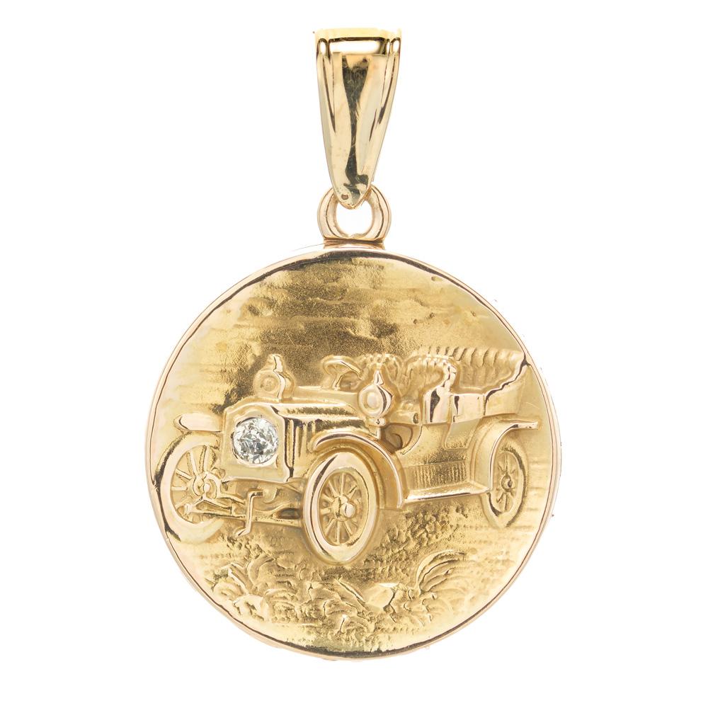 Early 1900's diamond locket pendant. 2 dimensional hand crank Model T in 14k yellow gold with a round cut diamond. 

1 old mine cut diamond, H VS approx. .10cts
14k yellow gold
Stamped: 14k
5.4 grams 
Top to bottom: 37mm or 1.45 Inches 
Width: