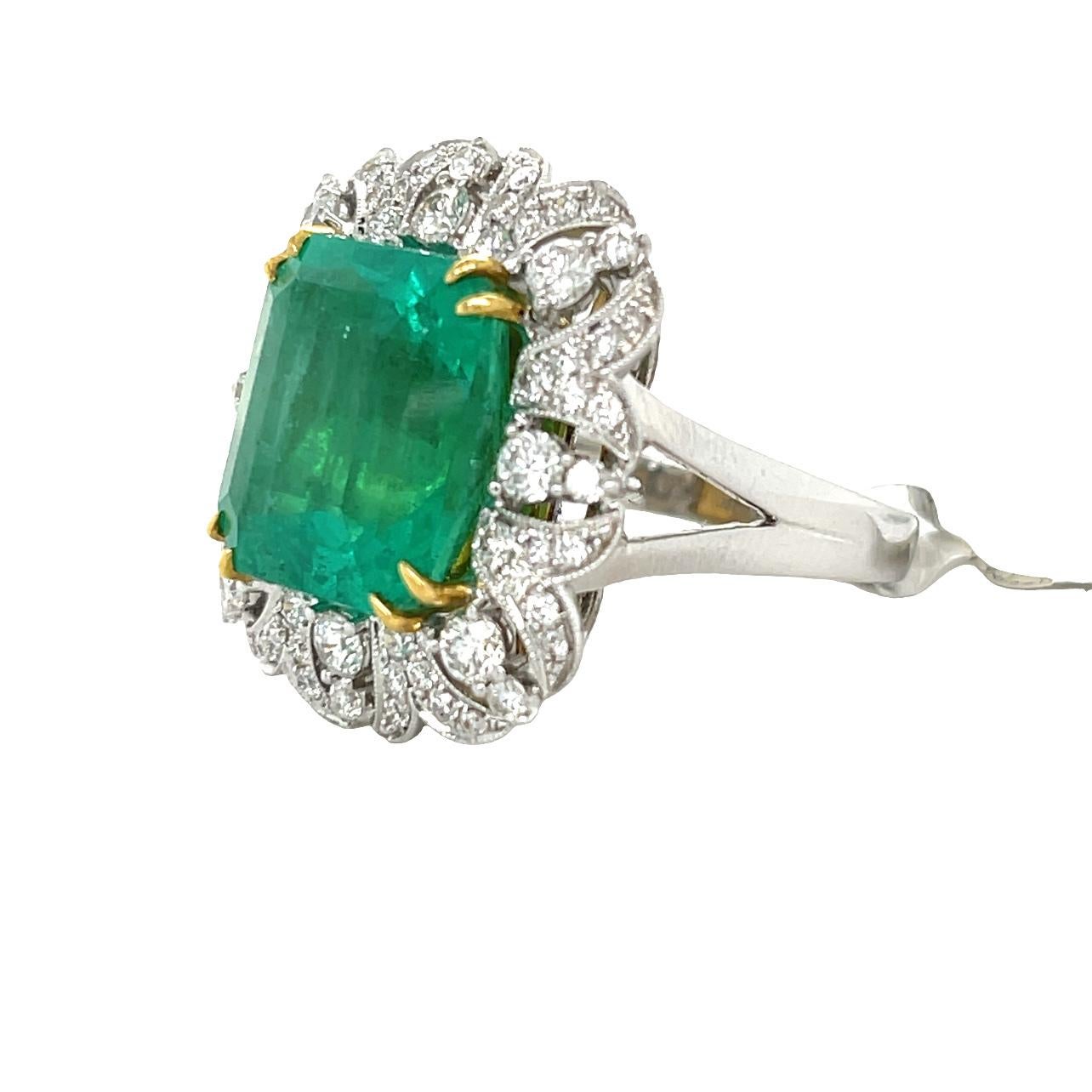 This stunning Statement ring has a 12.5x13mm emerald cut Zambian Emerald with 8 prong setting in 18 karat white and yellow gold. There are top quality sparkling brilliant cut diamonds surrounding the center piece for added elegance. This beautiful