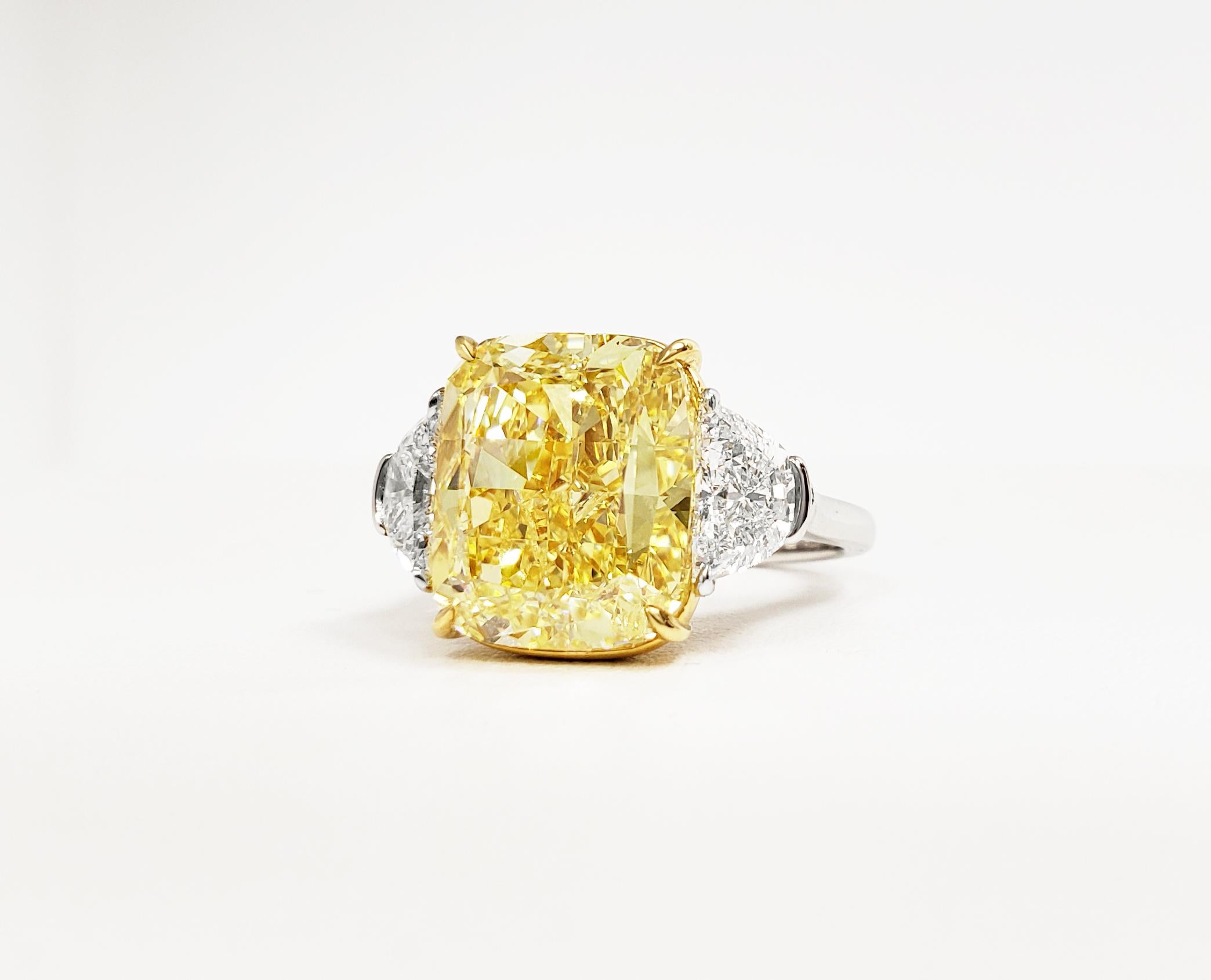 Scarselli Classic Ring with 10.11 carat Fancy Intense Yellow Diamond, cushion cut, VS1 clarity GIA certified, mounted in 18k yellow gold basket. Accompanied by two side halves white diamonds 1.38 TCW This ring may be sized or re-designed with