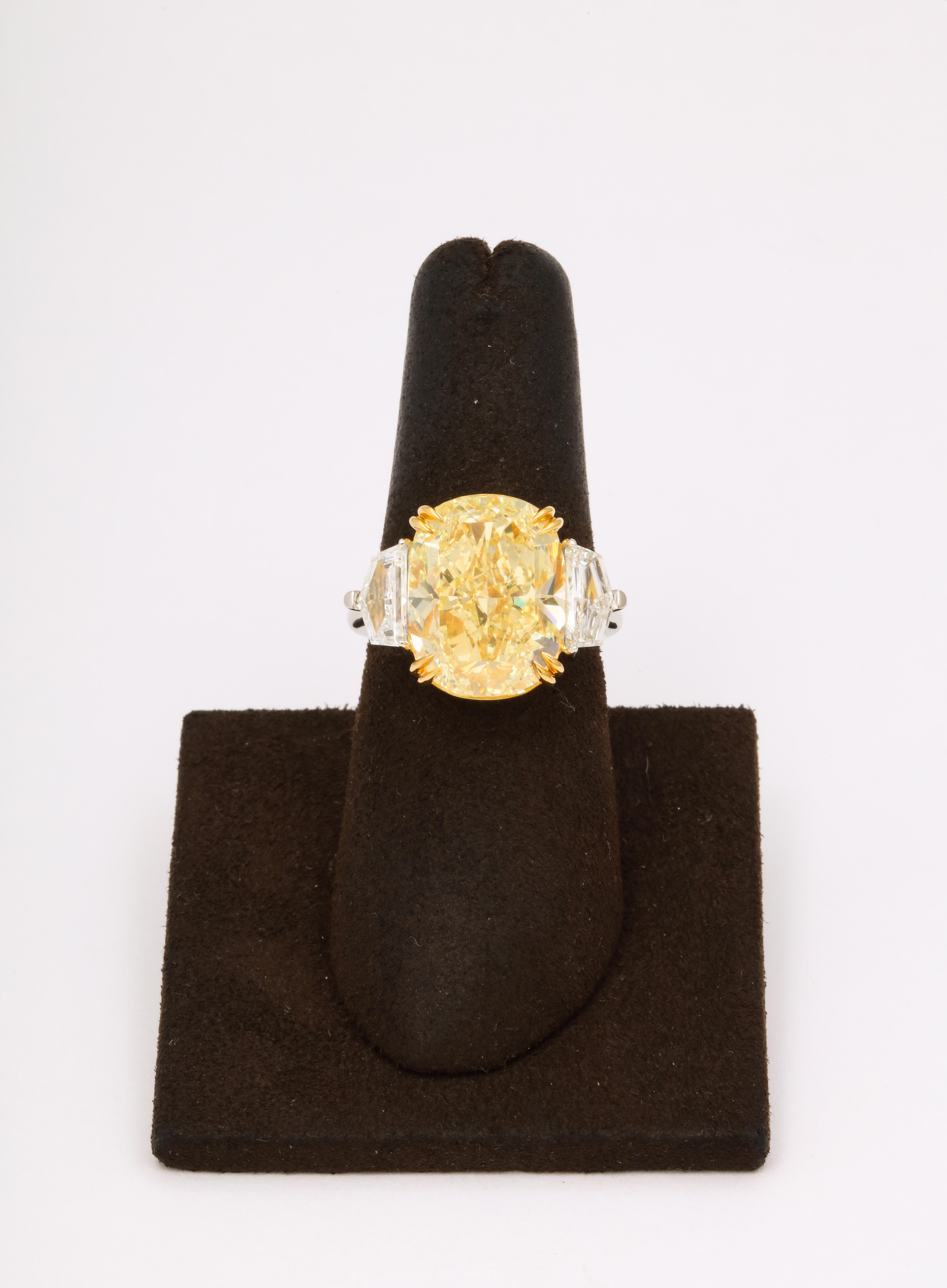 
An INCREDIBLE rock! 

10.01 carat GIA certified Fancy Yellow, VS1 cushion cut center diamond. 

Set with 1.61 carats of white side diamonds. 

The center diamond measures 14.64 x 11.54 mm!

Custom Platinum and 18k yellow gold mounting. 

Currently