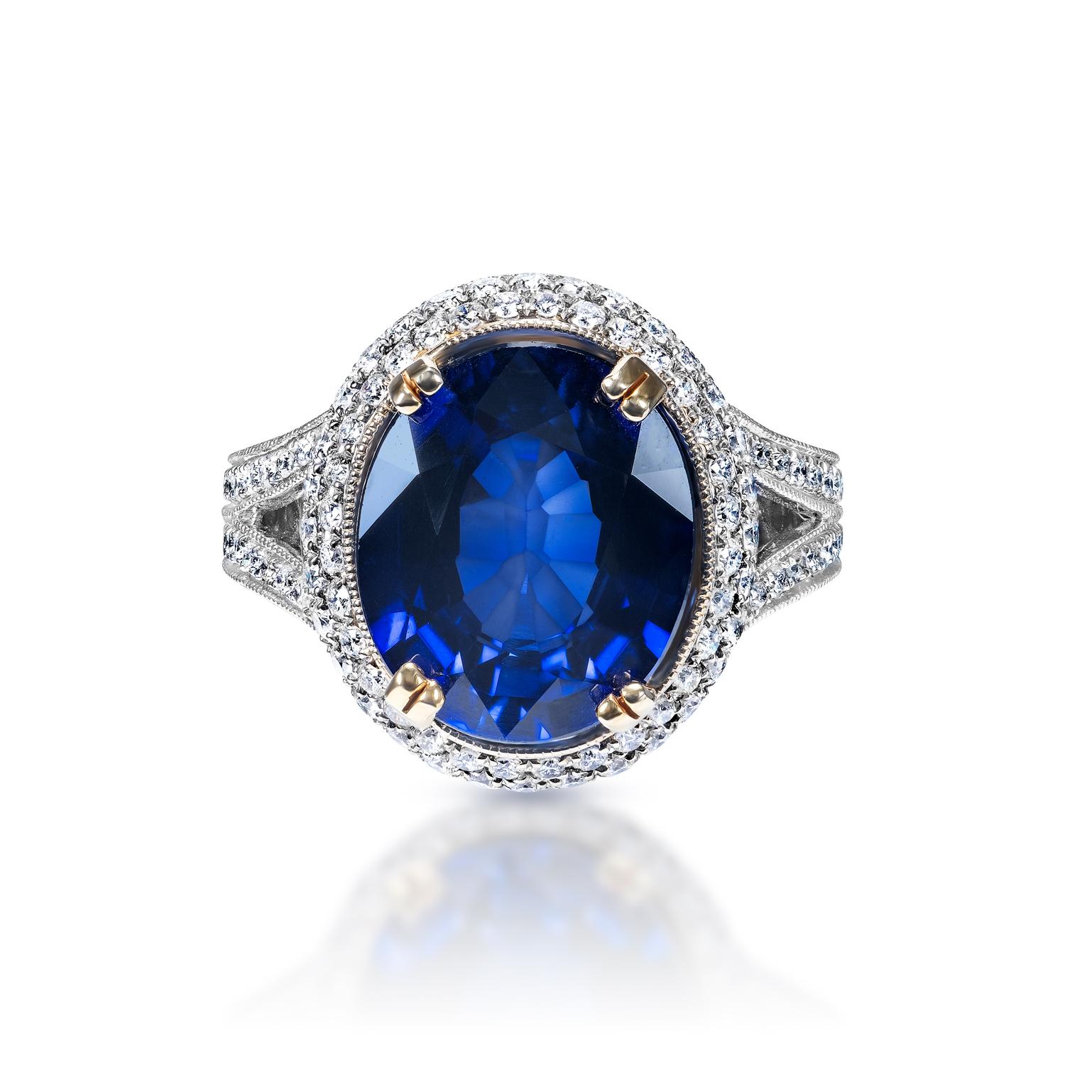 Center Stone Sapphire Ring:
Carat Weight: 7.70 Carats
Color: Blue Sapphire - Diffused J’adore Sapphire
Style: Oval Cut

Carat Weight: 1.90 Carats
Shape: Round Brilliant Cut
Settings: Halo & 4 Double Prong
Metal: 18 Karat White Gold


Total Carat