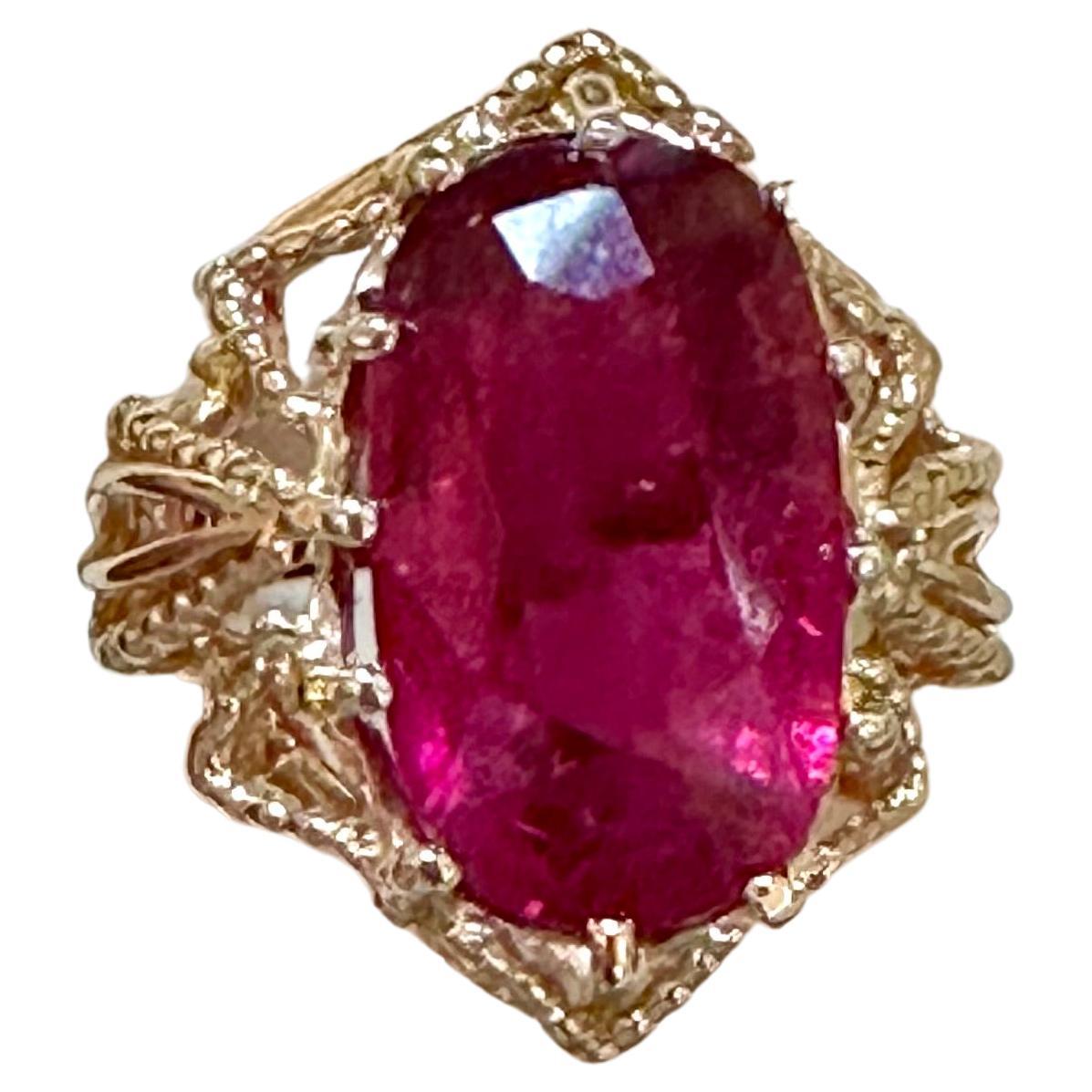 Approximately 10 Carat Oval Cut Natural Pink Tourmaline 14 Karat Yellow Gold Ring
10 Carat of Pink Tourmaline , Oval shape 
Gold: 14 Karat Yellow  gold , Beautiful design
Weight: 6.5 gram Including stone

Ring Size 6 ( can be altered)
 Very good