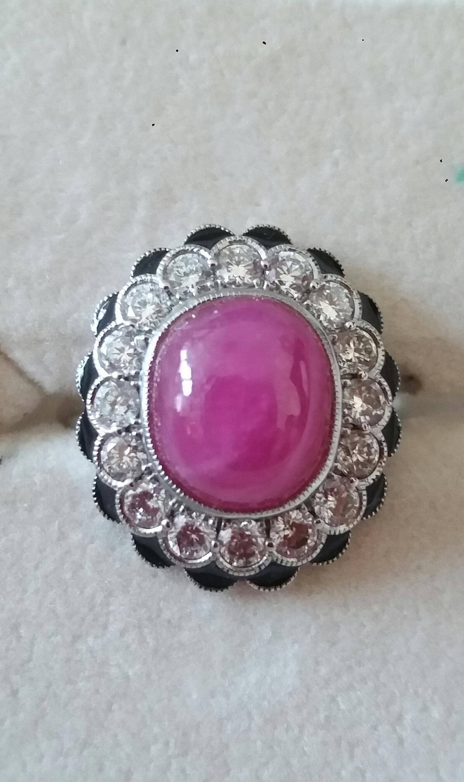 Classy Art Deco 14 White Gold Ring with a 10  Carats Oval Ruby Cabochon measuring 9x11 mm surrounded by 16 full cut brilliant cut diamonds for a total weight of 1,06 Carat...In the outer circle we have 16 little rounded triangles in red enamel