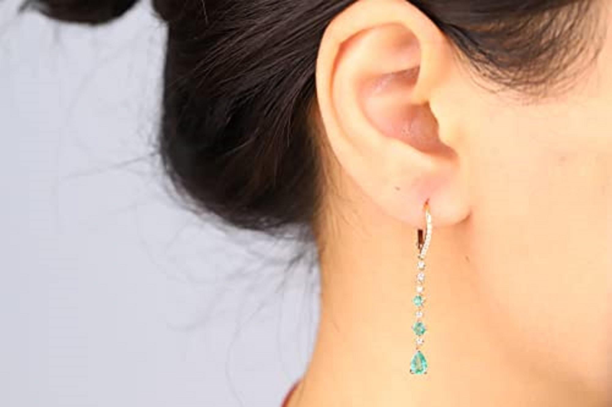 Decorate yourself in elegance with this Earring is crafted from 14-karat Yellow Gold by Gin & Grace. This Earring is made up of 6x4 Pear Emerald (2 pcs) 0.67 carat, 2.5MM Round-Cut (2 pcs) 0.11 Carat, 3MM Round-Cut (2 pcs) 0.20 and Round-cut White