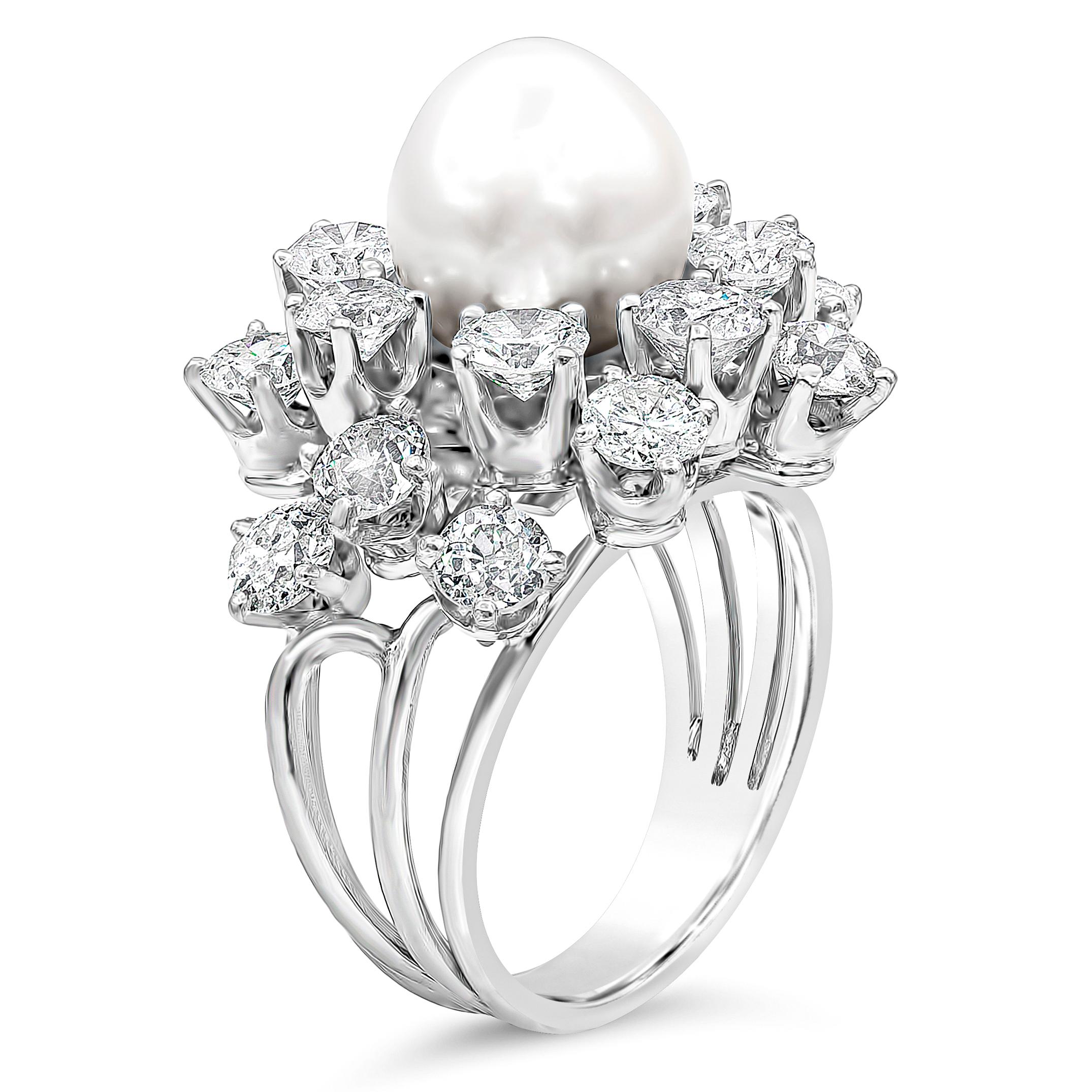 A beautiful cocktail ring showcasing a 10 carat pearl, accented with 17 brilliant round diamonds halo. Set in polished platinum setting. Diamonds weigh 4.25 carats total. Size 7 US.

