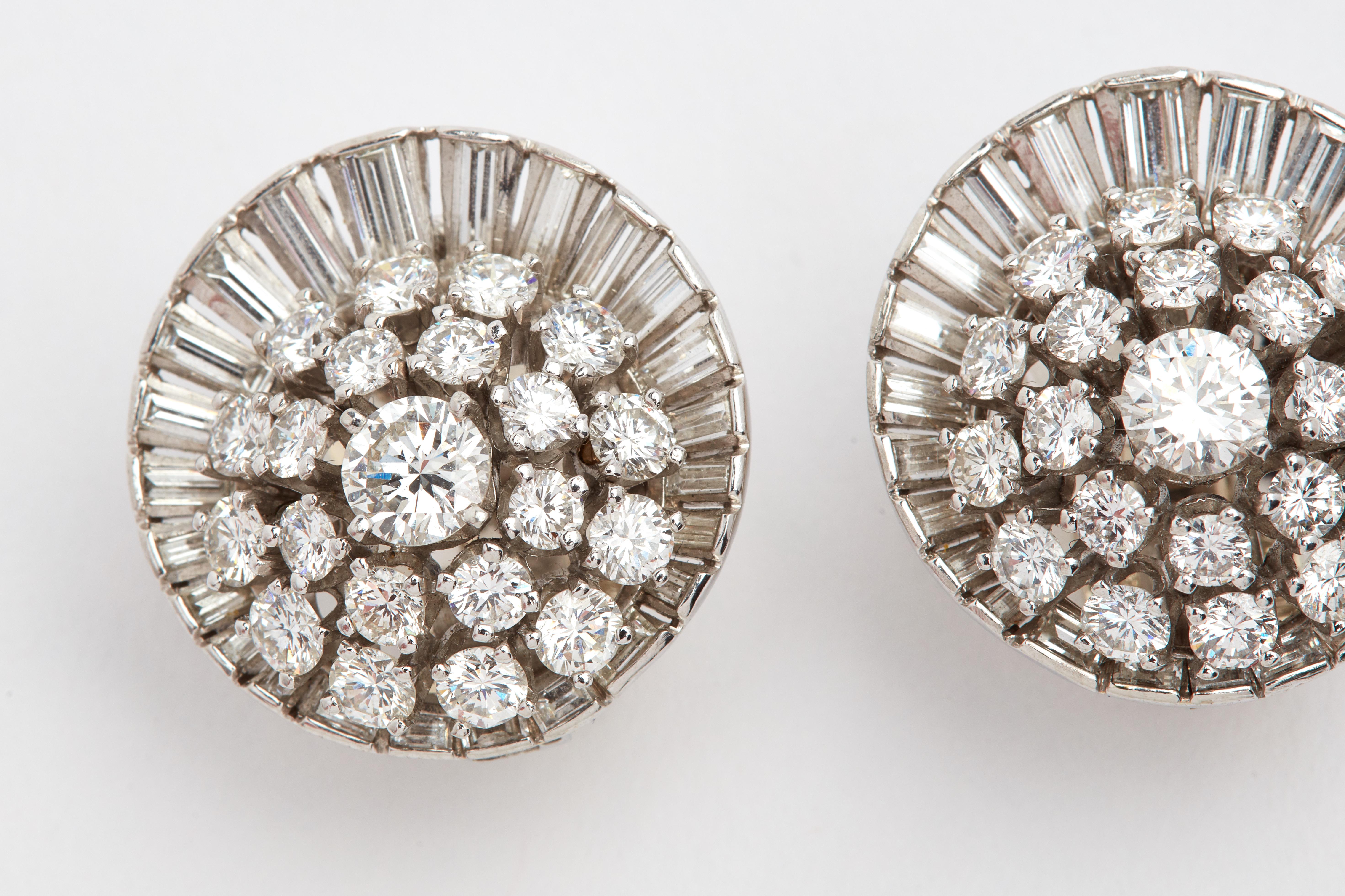 Platinum Satellite Diamond Ear Clips with aprox 10 carats of white diamonds. 1 inch in diameter. 50 Baguettes (aprox 3.50 carats). 48 Round diamonds (aprox 5 carats) 2 center diamonds weighing aprox 1.50 carats total. G color and VS quality Diamonds 