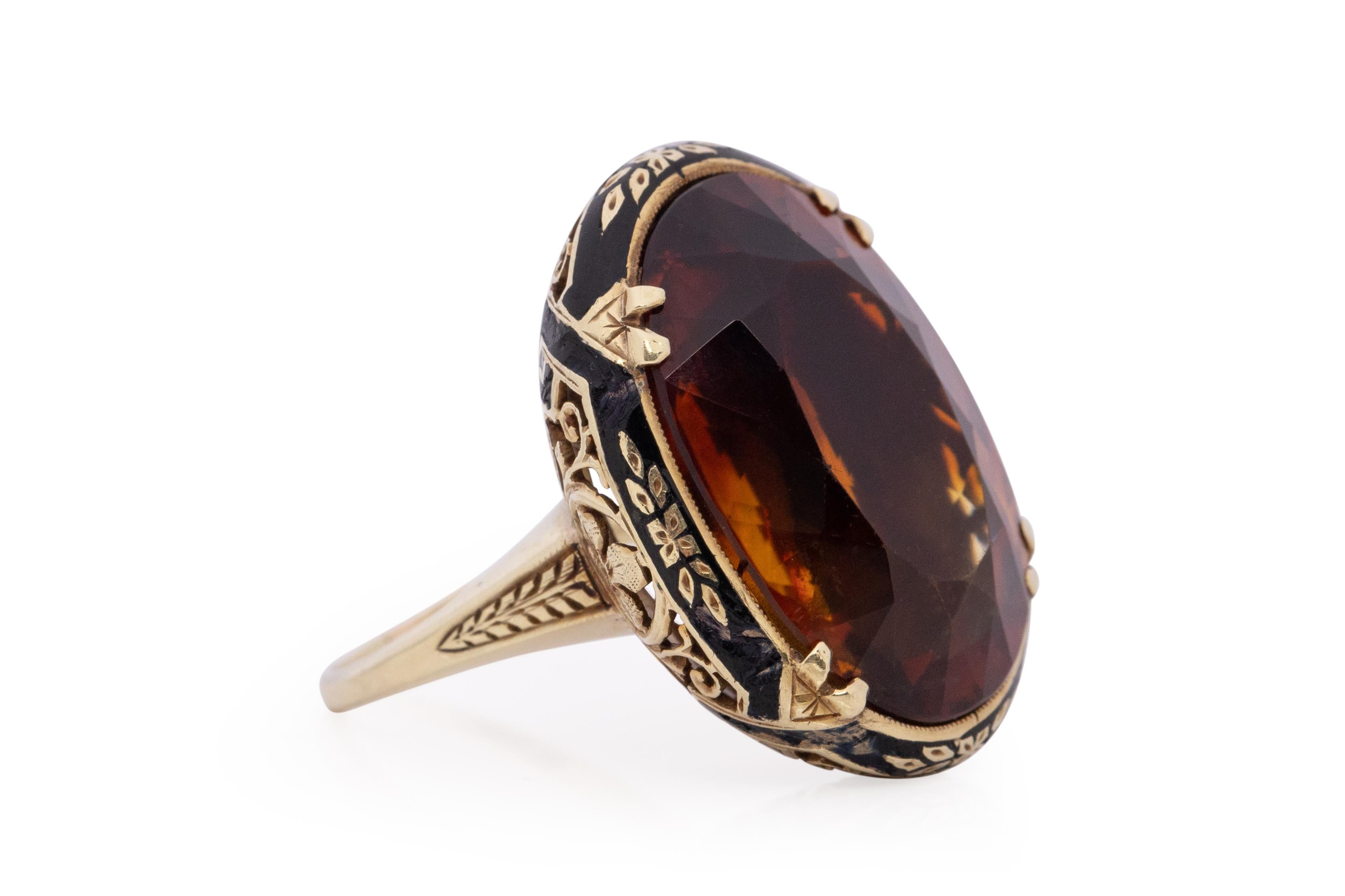 Item Details: 
Ring Size: 6.5
Metal Type: 14 Karat Yellow Gold [Hallmarked, and Tested]
Weight: 9.0 grams

Center Stone Details:
Type: Citrine, Natural, Dark Orangy Brown
Weight: 10 carat
Cut: Oval
Clarity: Central feather

Note: Beautiful enamel