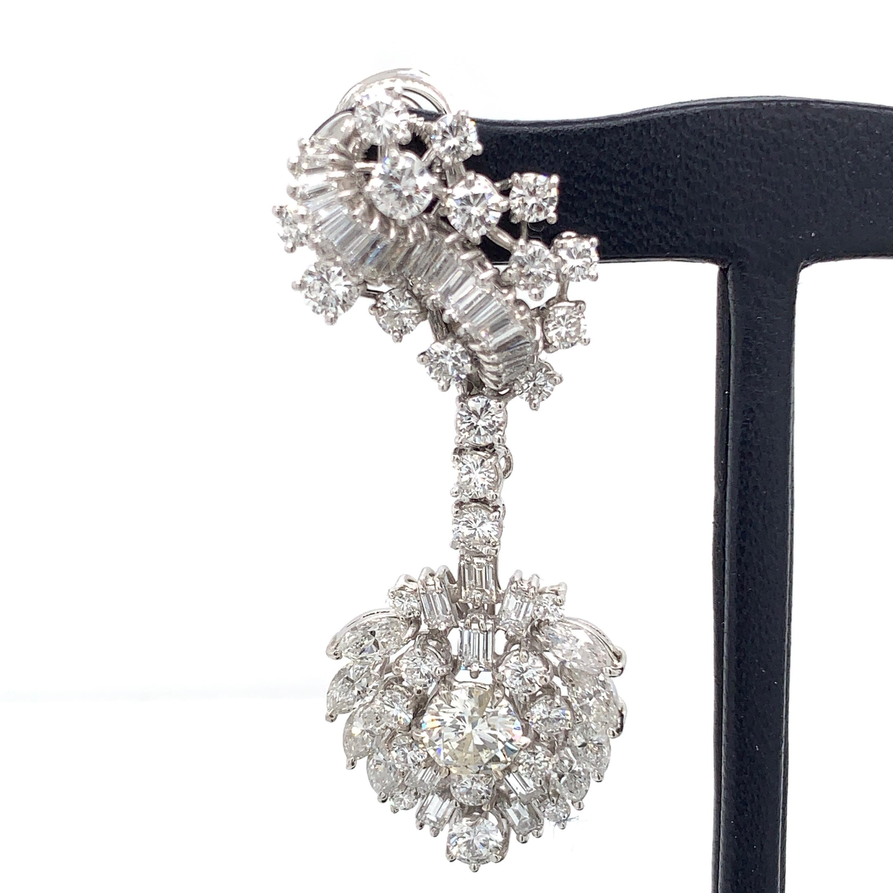 These spectacular estate earrings, circa 1970, feature approximately 11 carats of round and fancy shape diamonds. 

Center stone weight are approximately .75 carats each.
G-H color VS2-SI1 clarity. 

These cluster style drop earrings are set in 18k