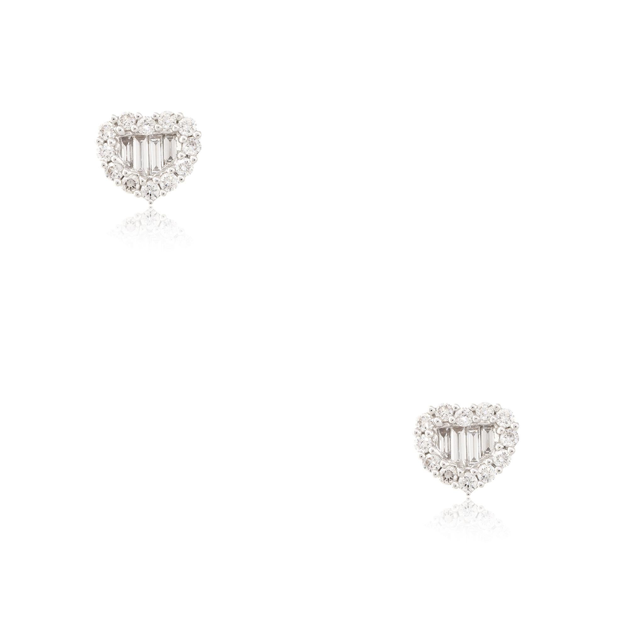 18k White Gold 1.0ctw Round Brilliant and Baguette Diamond Heart Stud Earrings
Material: 18k White Gold
Diamond Details: Approximately 1.0w of Round Brilliant and Baguette Cut Diamonds
Item Dimensions: 10.5mm x 3.3mm x 9.13mm 
Earring Backs: