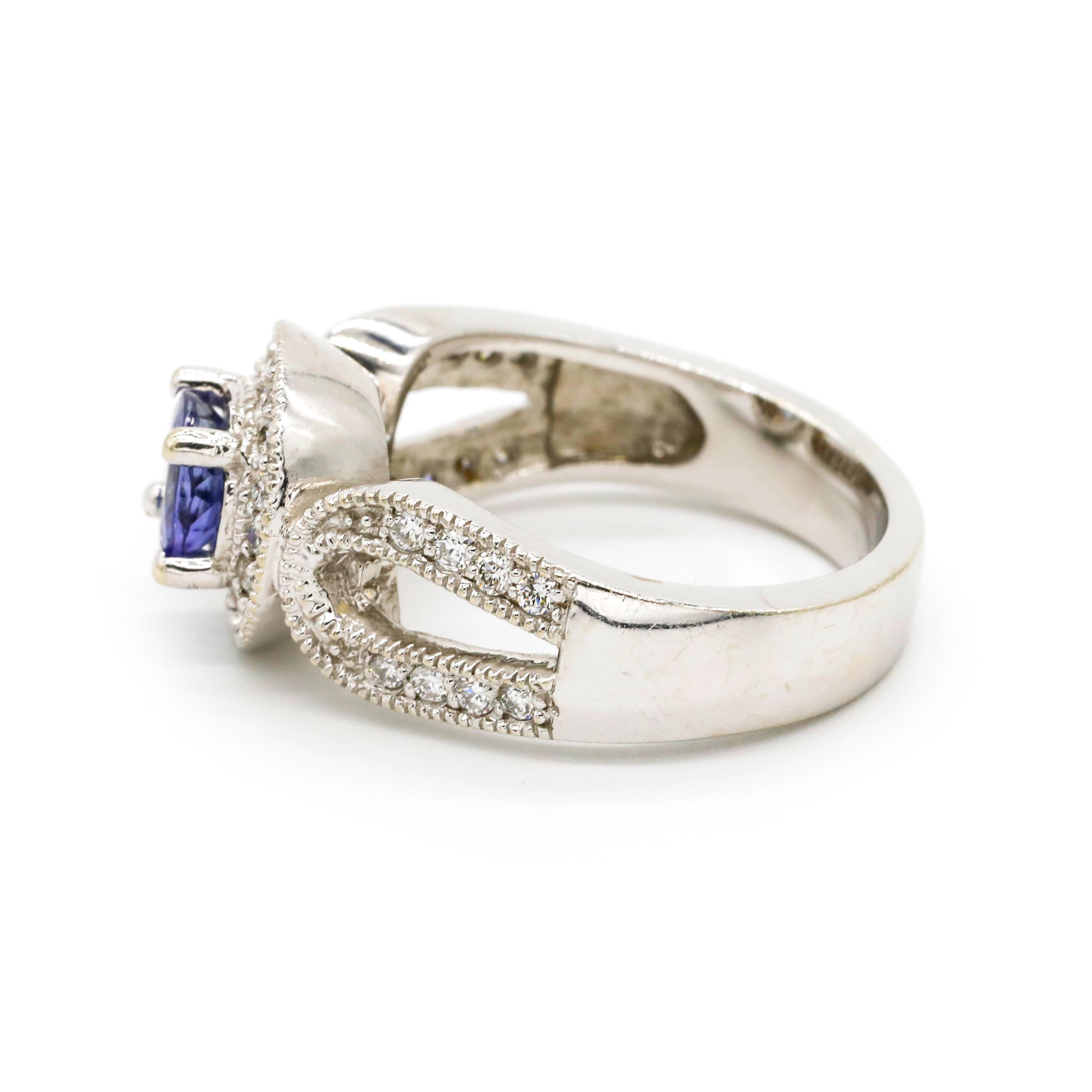 1.0 Carat Round Tanzanite 0.50 Carat Diamond 14 Karat White Gold Fine Halo Ring

Crafted in 14 kt White Gold, this Unique design showcases a Tanzanite 1.0 TCW round-shaped Tanzanite, set in a halo of round-cut mesmerizing diamonds, Polished to a