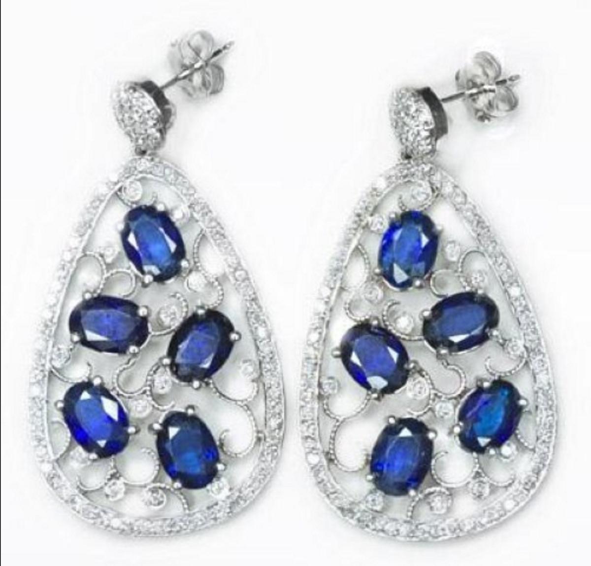 10 carats of natural sapphires and 1.5 carats of natural diamonds. The blue color is gorgeous and is well complimented by the white diamonds. The sapphires each measure 7mm x 5mm and are surrounded by a filigree pattern with lovely milgrain. There