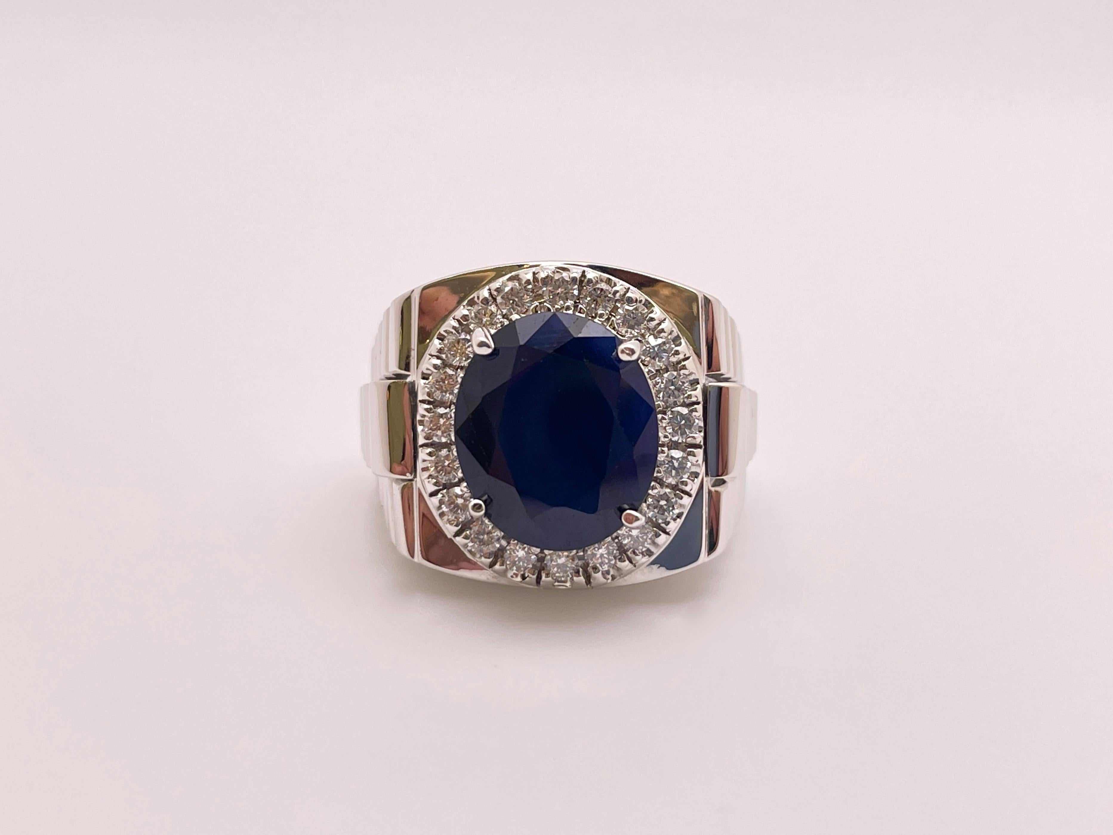 An original 14K white gold sapphire and diamond ring. Mounted with one magnificent oval-circular cut natural blue sapphire. 

Measuring approximately 13.30 x 10.80 x 7.18 mm, weighing approximately 10 Carats (CT), boasting a very even rich dark blue