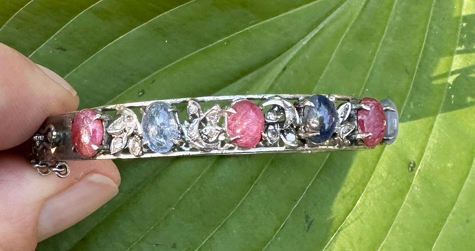 This is an absolutely magnificent antique Natural Multicolor Sapphire, Star Sapphire and Old Mine Cut Diamond Bangle Bracelet in Silver.  The extraordinary jewel is set with eight Natural Mined Multicolor and Star Sapphires of great beauty.  The