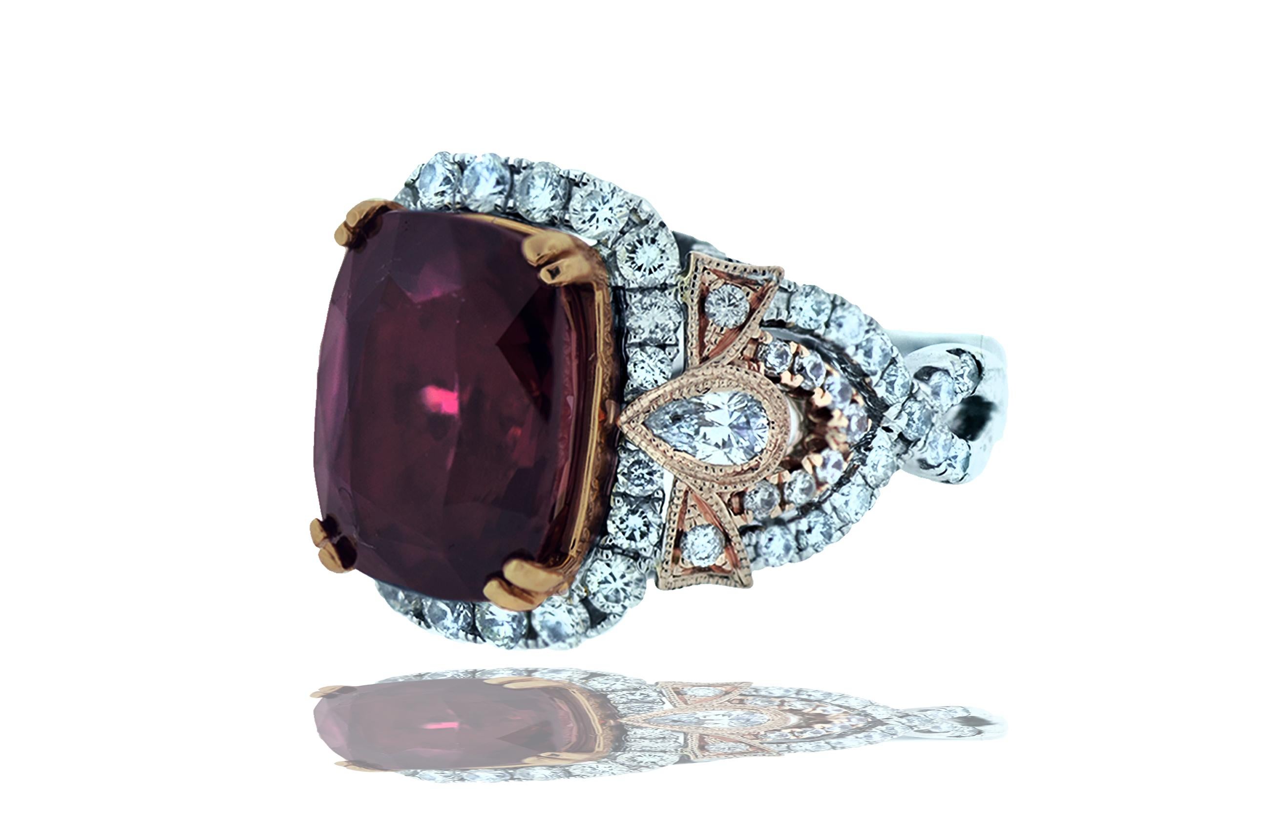 A beautiful hue rarely seen, this stunning mauve burgundy color can be seen in this impressive 10 carat cushion cut Spinel.  This center stone is accented by .50 carats of white F-G VS round brilliant diamonds set in a bright cut style.  The