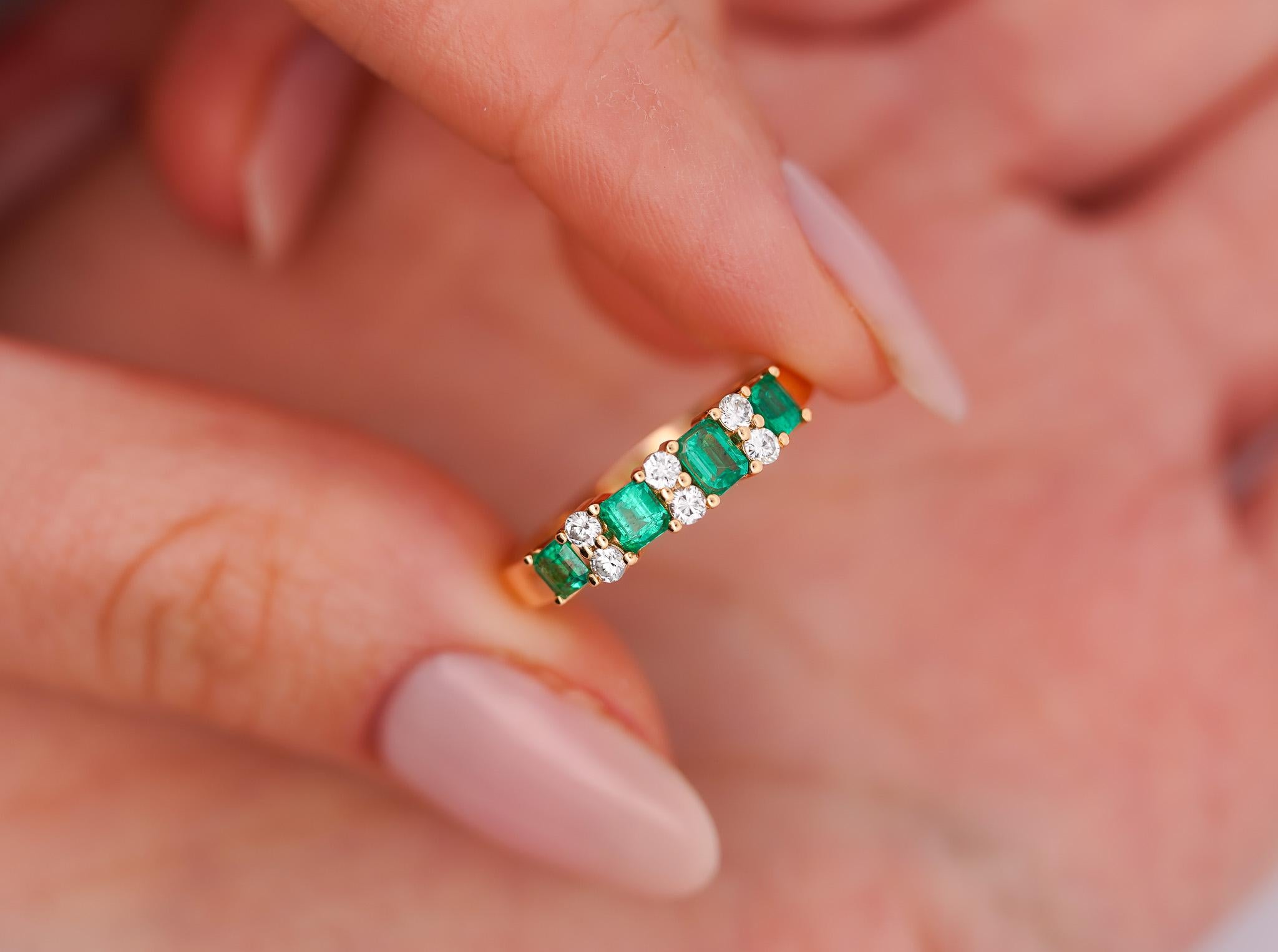 1 carat total natural emerald and diamond band ring in 14k solid yellow gold. The emeralds are rich with color, a vivid green shine with excellent luster and brilliance. A simple but unique emerald band that you will not find elsewhere. 100%
