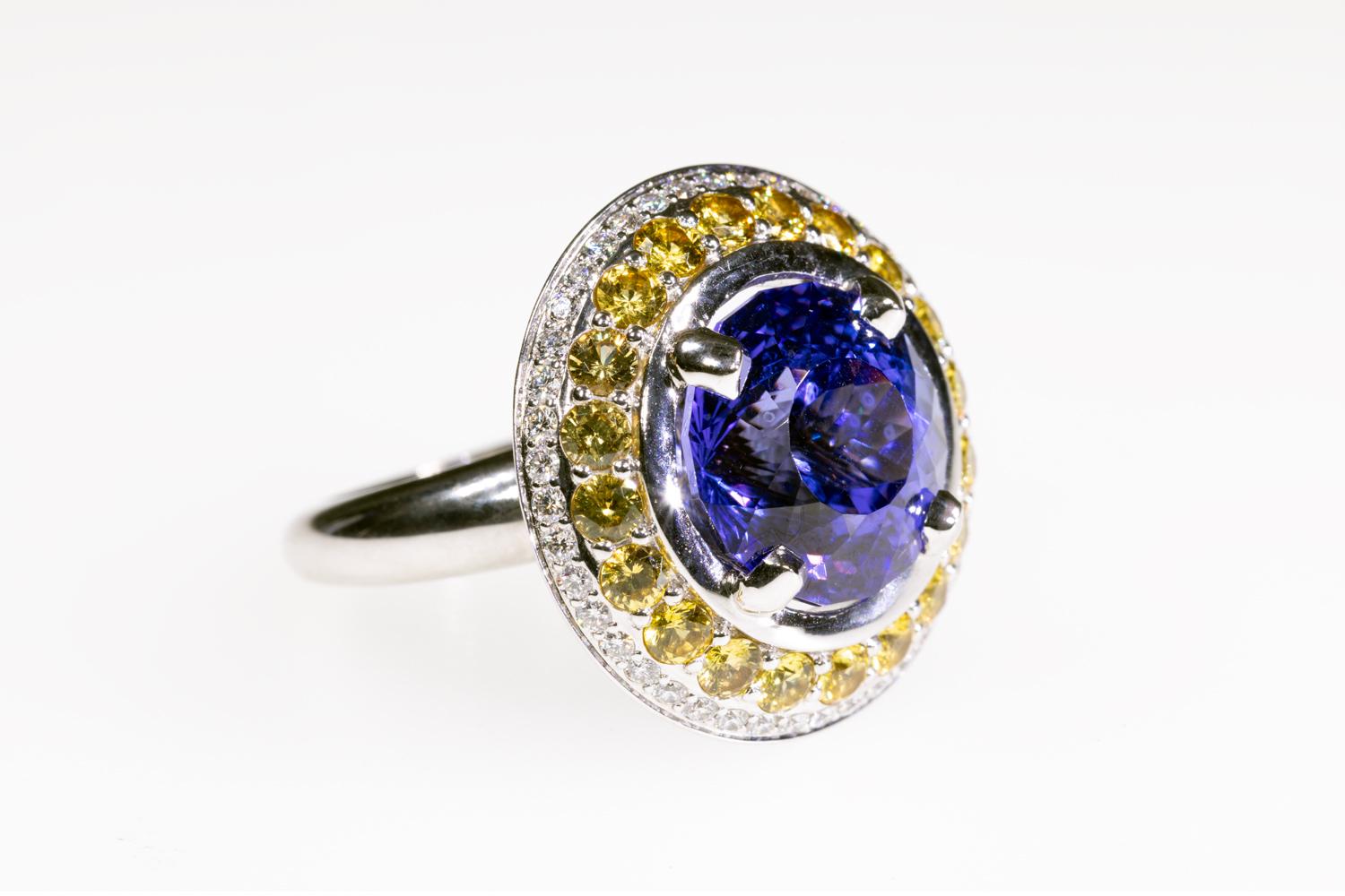 Round Cut 10 Carat Tanzanite Cocktail Ring in 18K WG with Yellow Sapphires & Diamond Halo For Sale