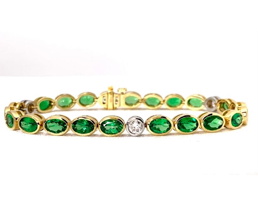 This gorgeous 18k yellow and white gold tennis bracelet features just over 10 carats of beautiful, bright green tsavorite garnets! January's birthstone comes in a variety of colors and these exquisite garnets have stunningly vivid color! Tsavorites