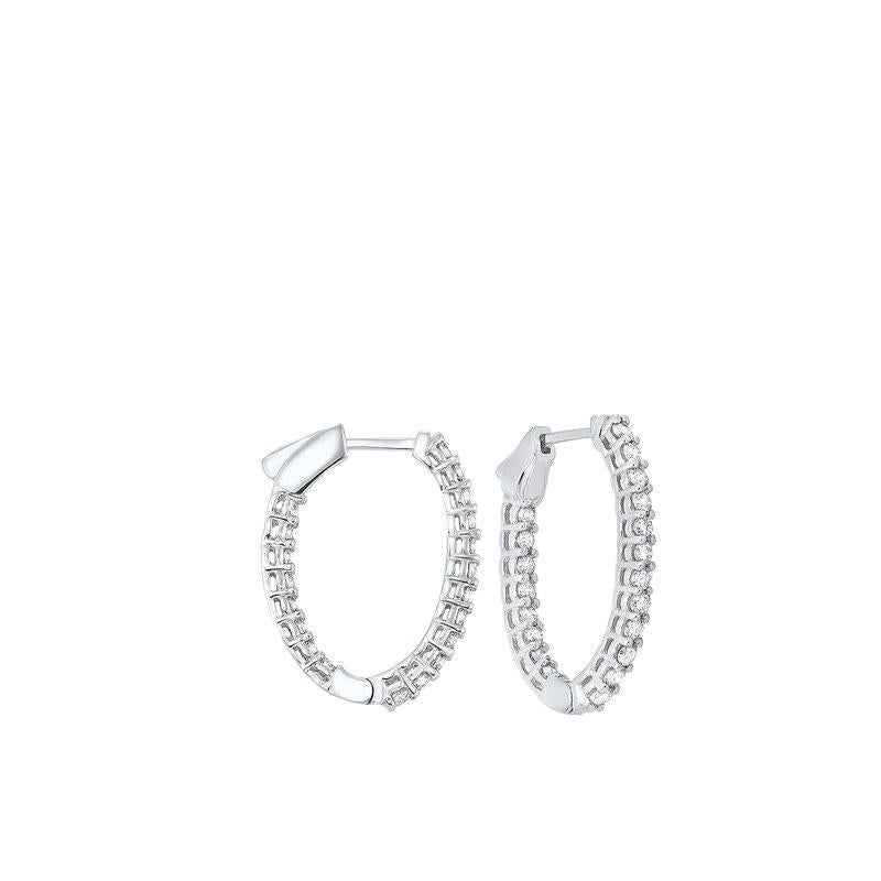 Nothing says luxury like an incredible pair of diamond hoop earrings. These stunning brightly polished 14 karat white gold inside out oval-shaped hoop earrings feature a total of 42 round brilliant cut diamonds totaling 10.00 carats are prong set on