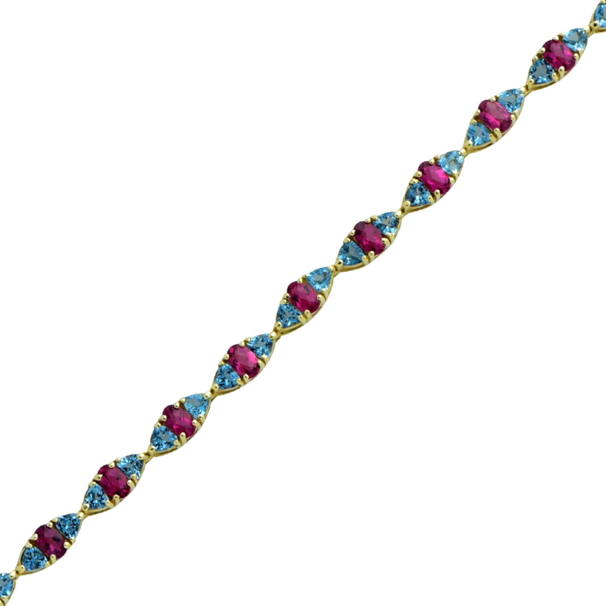14k yellow gold bracelet featuring 36 oval and trillion cut Tourmalines weighing approximately 10cts total. The tourmalines are set in an color alternating sequence, creating an eye-catching contrast of color. This dainty bracelet measures 7.5