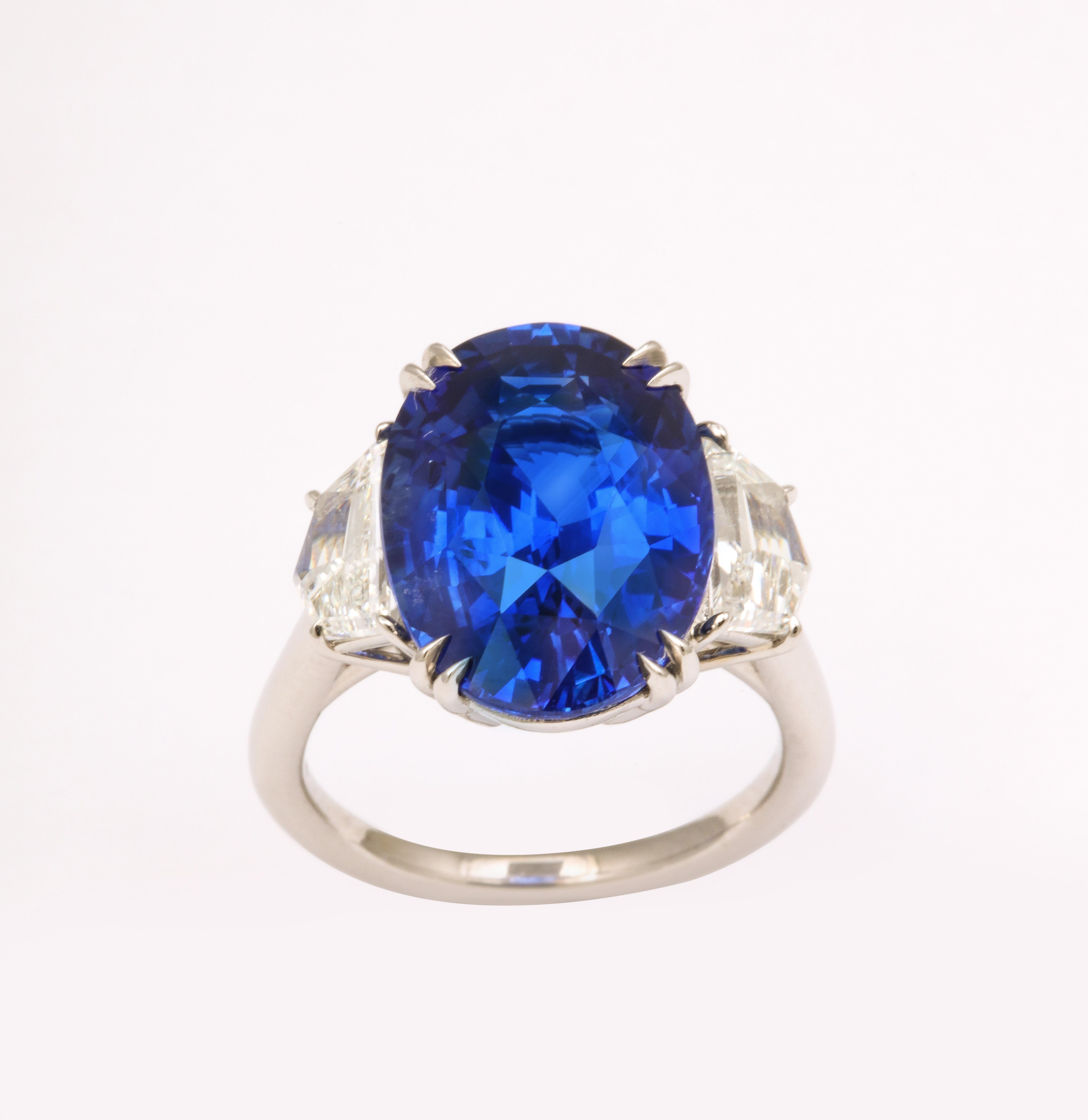 
A STUNNING ring! 

Certified, 10.02 carat Ceylon Vivid Blue oval sapphire.  Set in a custom platinum mounting with 1.10 carats of colorless white side diamonds. 

A size 6, this ring can be sized to any finger size. 

A beautiful and vibrant ring