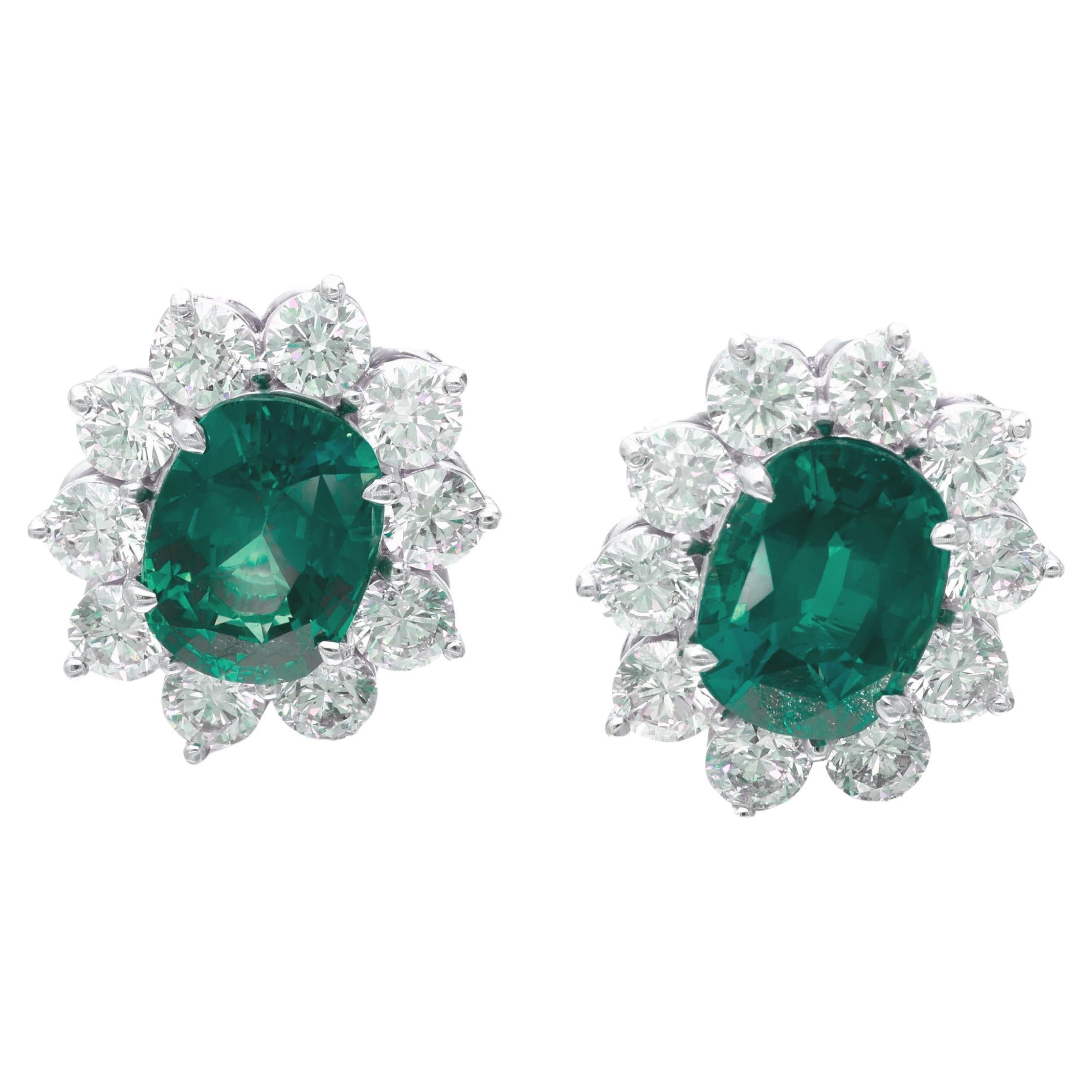 Featuring 2 oval-shaped sapphires, surrounded by 20 round diamonds.

Emeralds weighing 5 carats each
Diamonds weighing a total of approximately 5 carats
Platinum
