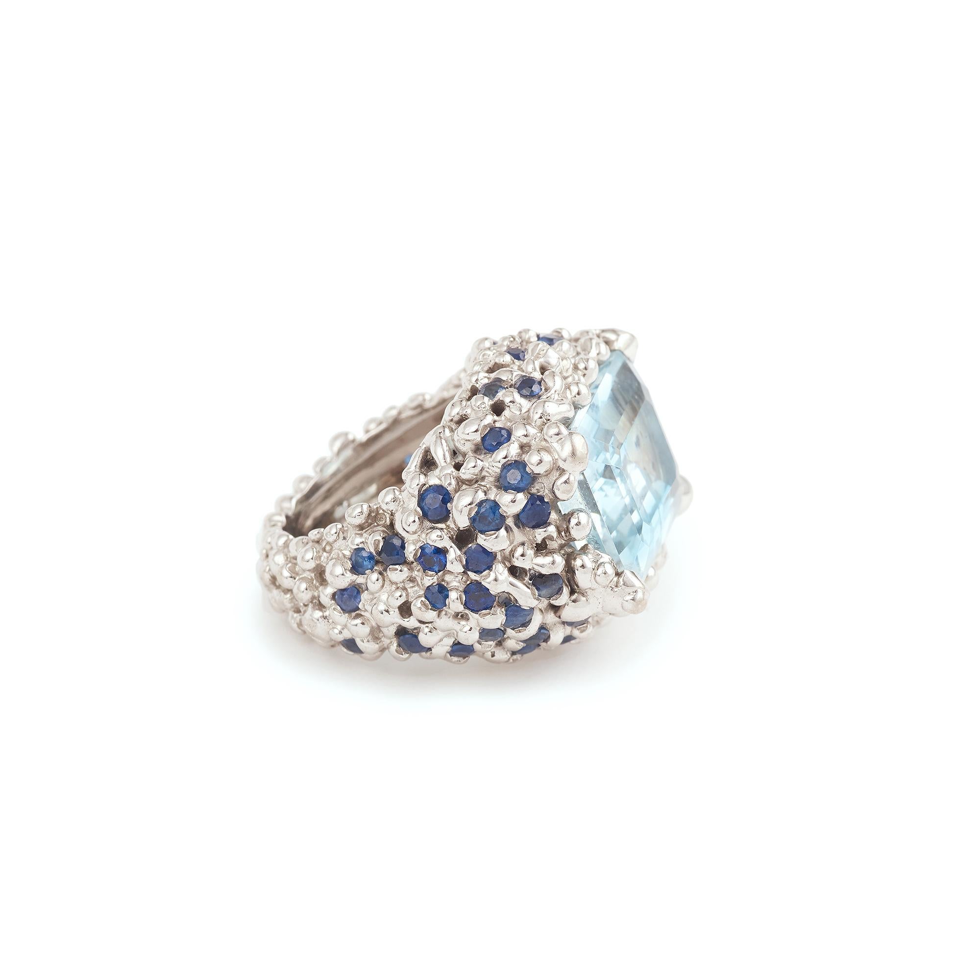 A large white gold Cocktail ring set with a rectangle-cut aquamarine and a pavement of brilliant-cut sapphires.

Antoine Camus workshop (not signed)!

Ring size: 20.59 x 26.13 x 10.09 mm (0.810 x 1.028 x 0.397 inches)

Aquamarine dimensions: 11.85 x