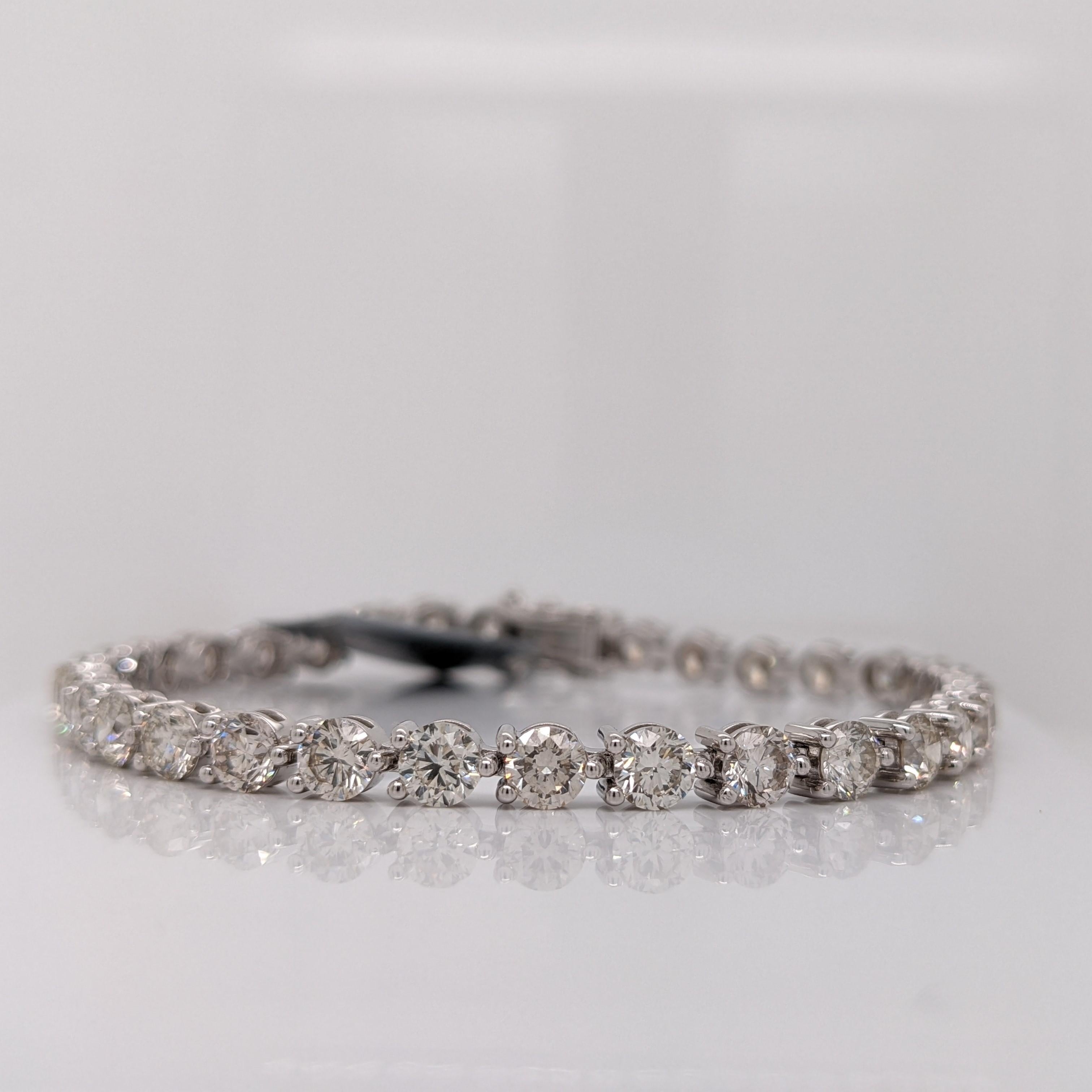 Introducing an exquisite natural diamond tennis bracelet that speaks volumes of elegance and luxury. Crafted in lustrous 14K white gold, this breathtaking piece showcases a remarkable 10 carats of scintillating round diamonds, captivating every eye