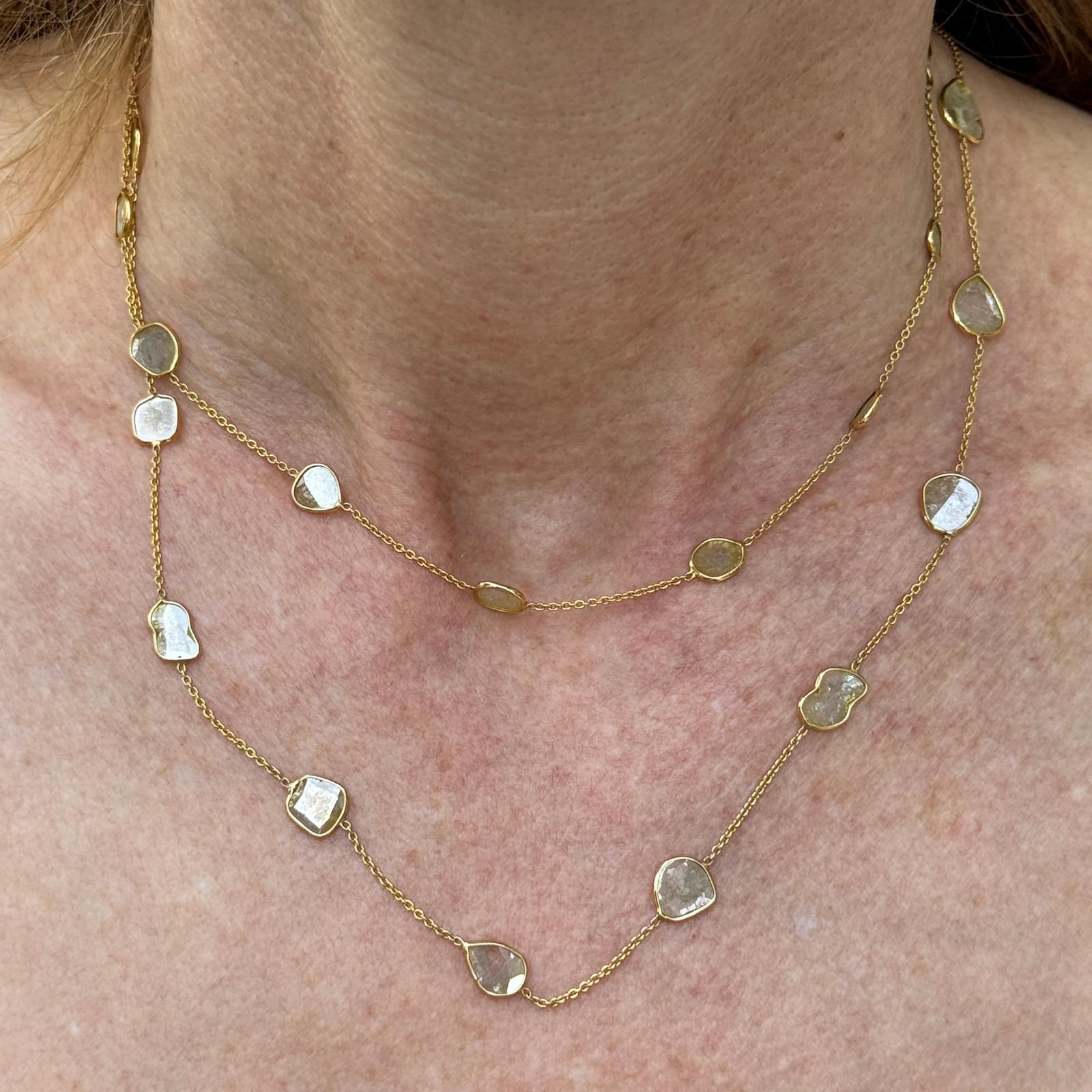 Diamond by the yard modern necklace crafted in 18 karat yellow gold. The necklace features 27 rose cut diamonds weighing approximately 10.0 carat total weight. The necklace measures 32 inches in length. Weight: 7.0 grams.