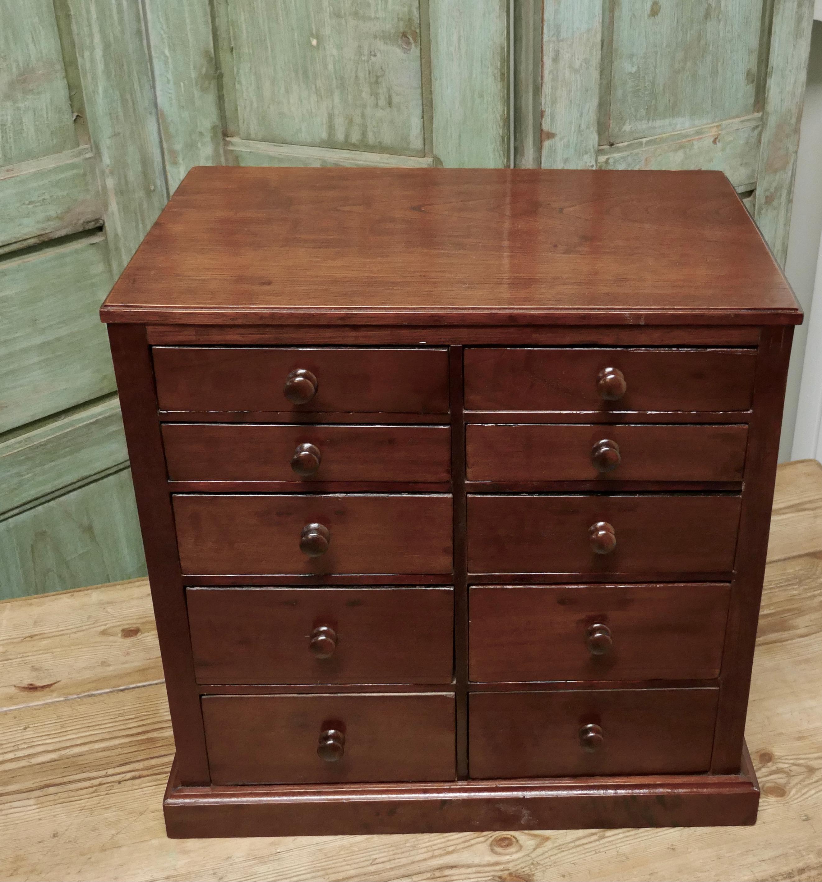 10-drawer mahogany collectors filing cabinet,
 
The cabinet has 10 drawers, each with a turned mahogany knob
The top 3 drawers on the right and the top drawer on the left have dividers, all the drawers are lined in blue sugar paper

The cabinet