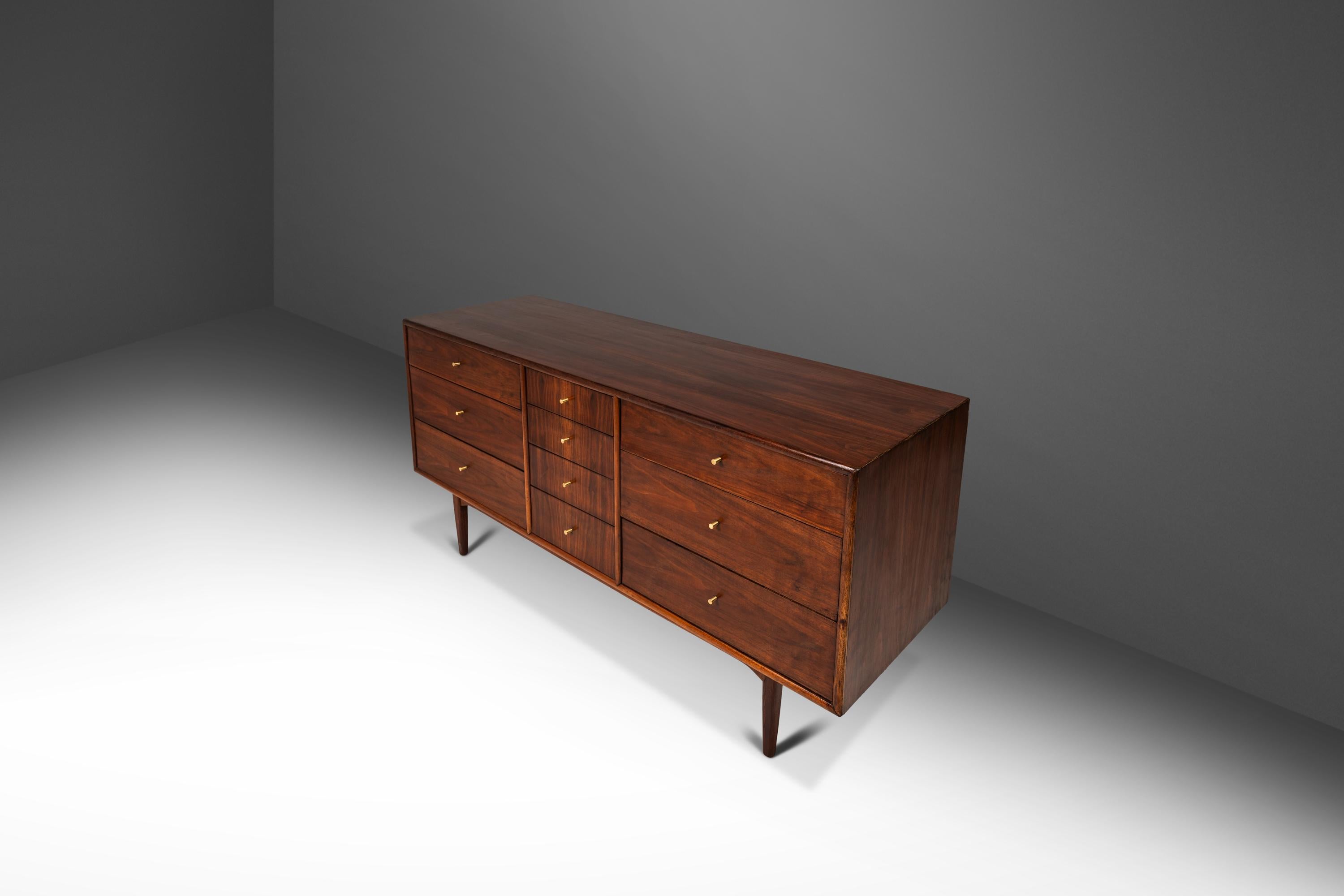 Introducing a rare 10-drawer dresser designed by the influential Kipp Stewart for the venerated Drexel Furniture Co. Built from a mix of solid and veneered American black walnut this gorgeous American icon functions well as both a credenza/TV stand