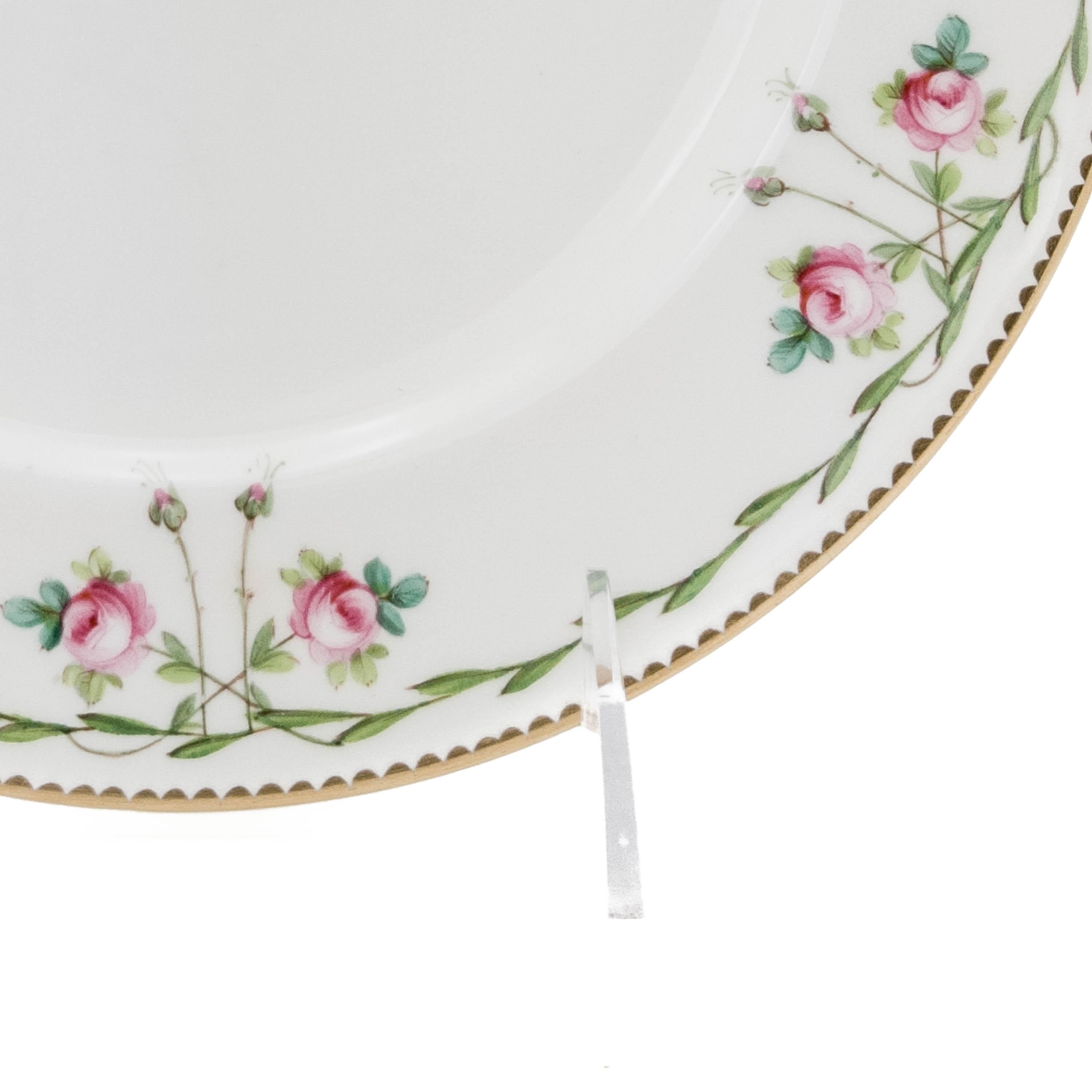 From Minton's of England a Classic design trimmed in 24-karat gold. Hints of turquoise green in the hand painted leaves with pretty rose surround on the collars. In nice antique condition with no chips or damage. Fully hall marked and dating to the
