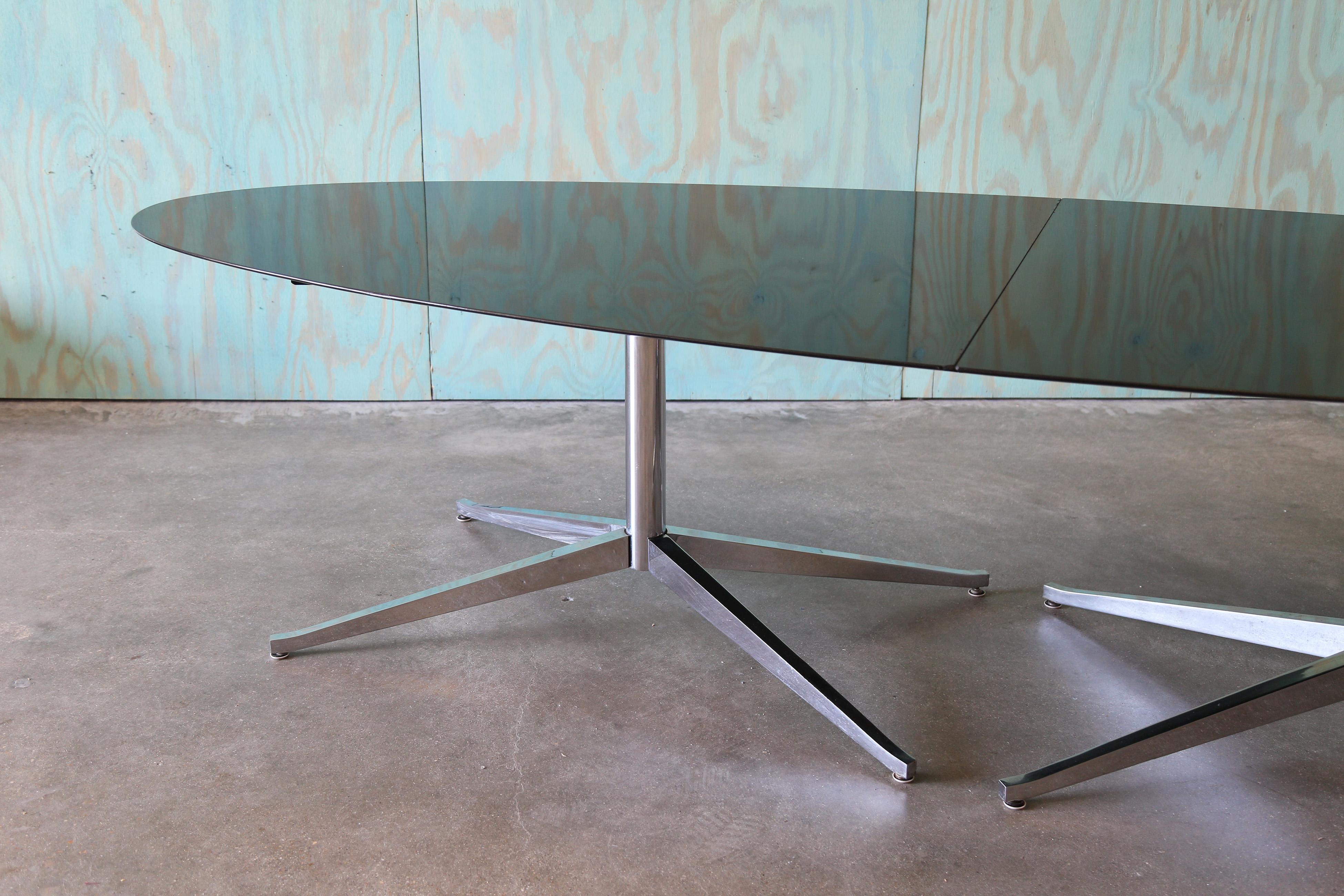 A 1960s mid century modern monumental double pedestal dining /conference table designed by Florence Knoll for Knoll spanning over 10’.  This table features two chrome pedestal bases and absolute black granite two piece top. Highly polished surface