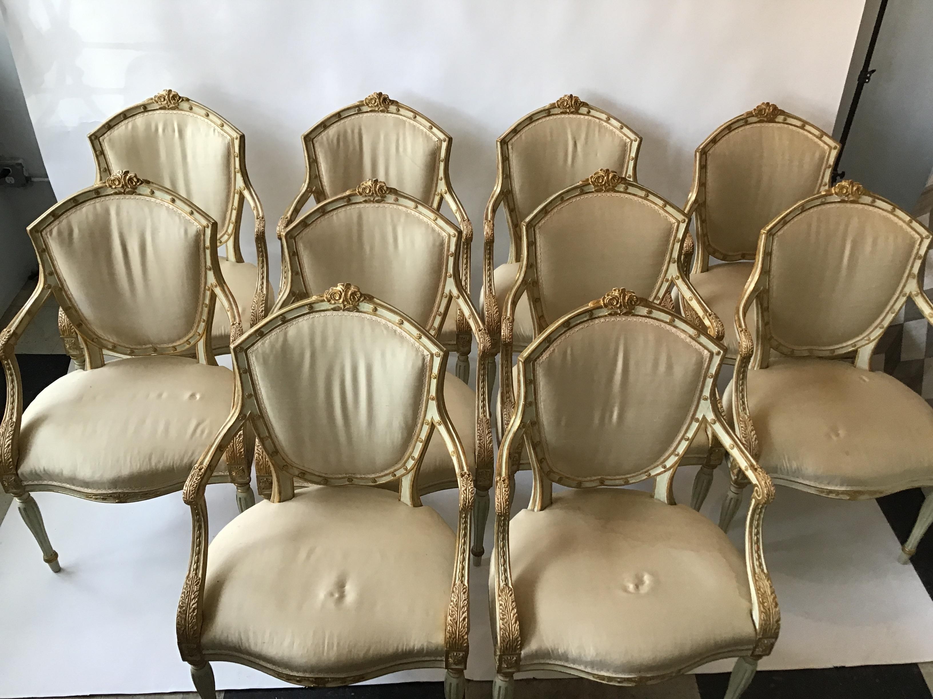 10 French style painted crème wood dining chairs with gilt accents. Hand carved. Out of a Southampton, NY estate. These chairs were recently appraised at 50,000.00 for the set.