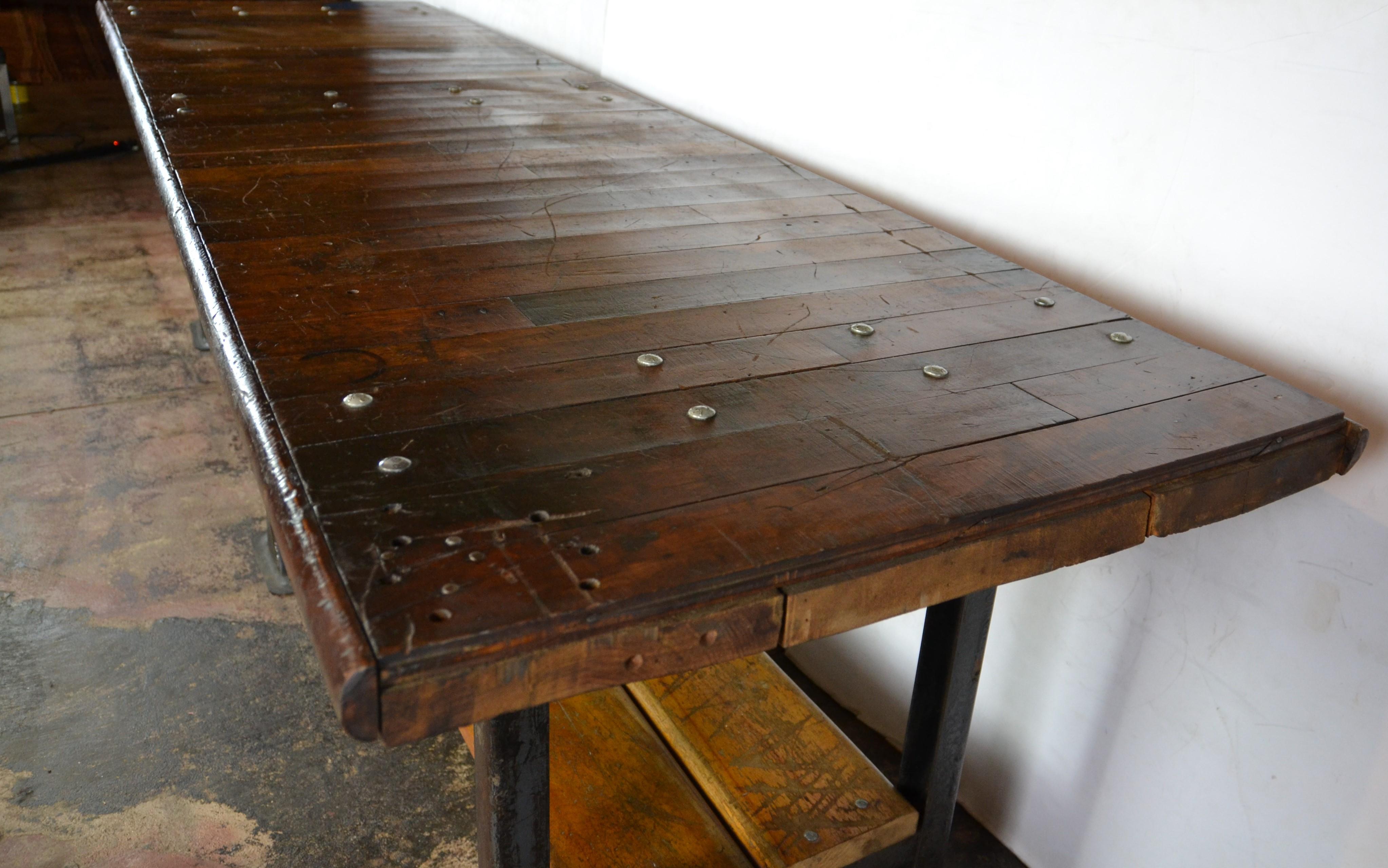 This is a huge, almost 10 ft long industrial table. Steel legs and fittings with a multi-plank top and under-shelf. Great patina to the wood.