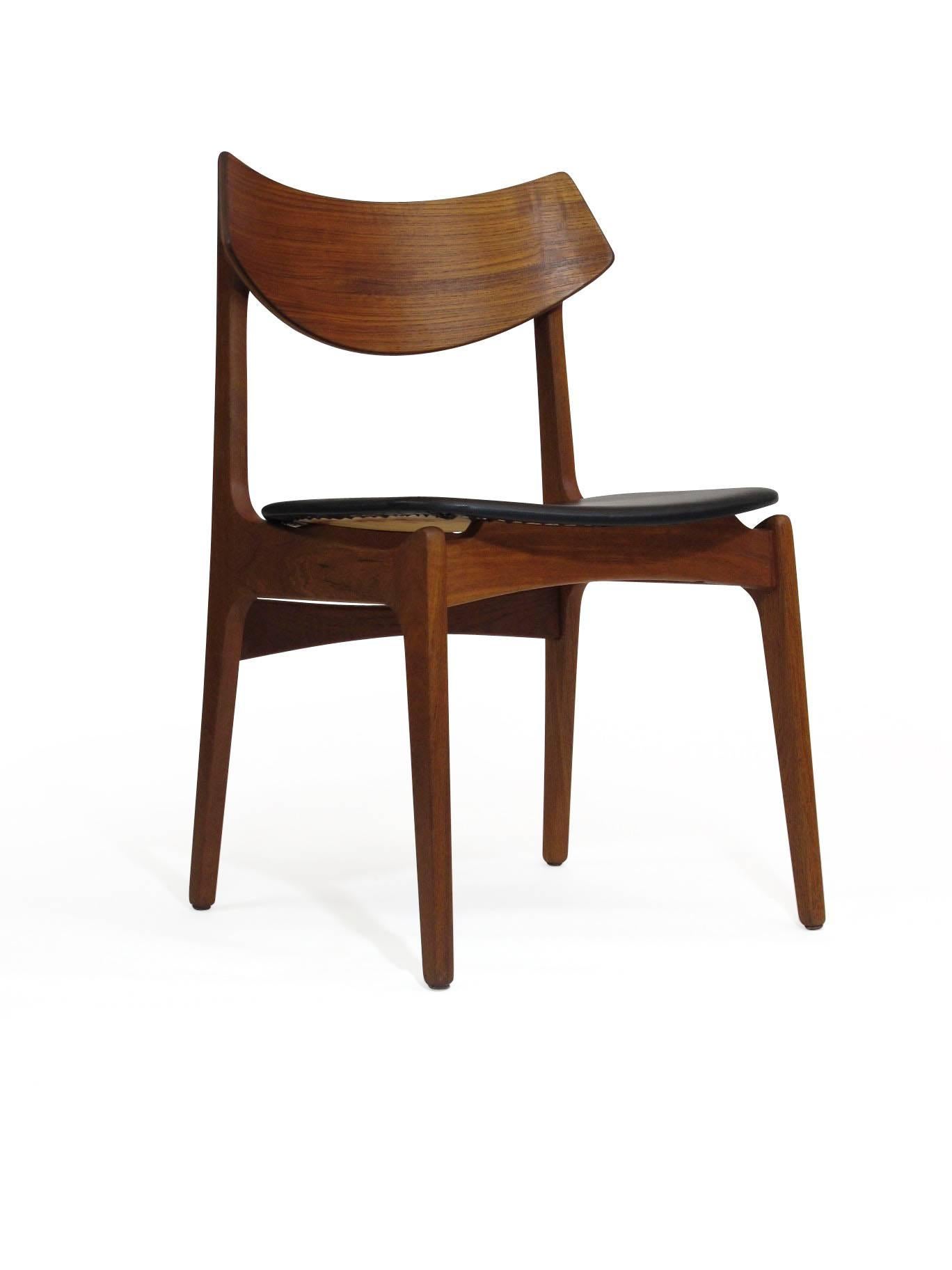Ten midcentury dining chairs designed by Funder-Schmidt & Madsen, Denmark. Teak frames with bold curved backs and black vinyl seats. Comfortable back rest. The teak has been professionally restored. The chairs can be sold in sets of four, six, or