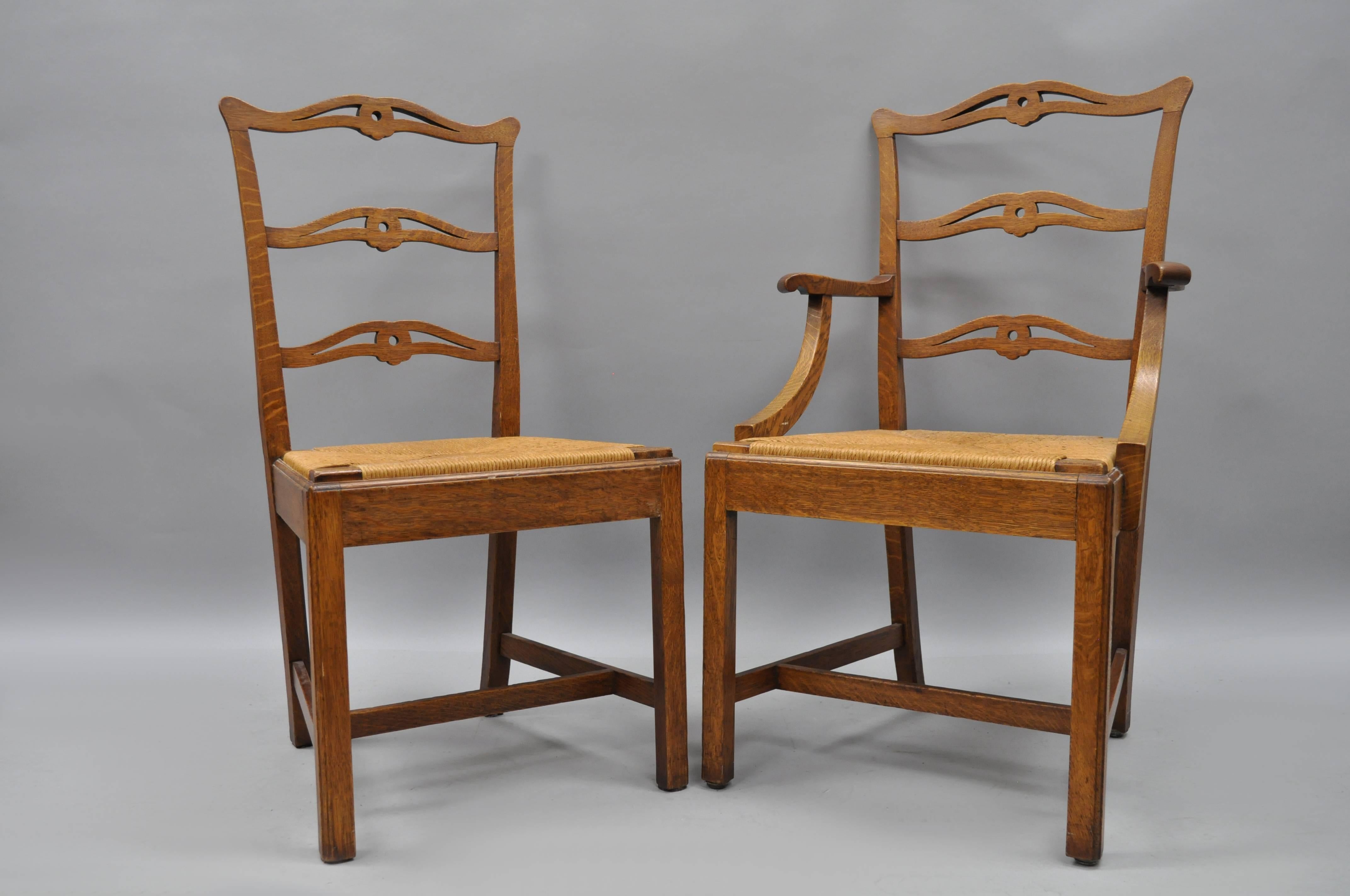 Set of ten antique golden tiger oak dining chairs, circa early 1900s. Set includes eight side chairs, two armchairs, woven rush seats, ladder ribbon backs, solid oak wood construction, beautiful wood grain. Six side chairs with lacquered woven rush
