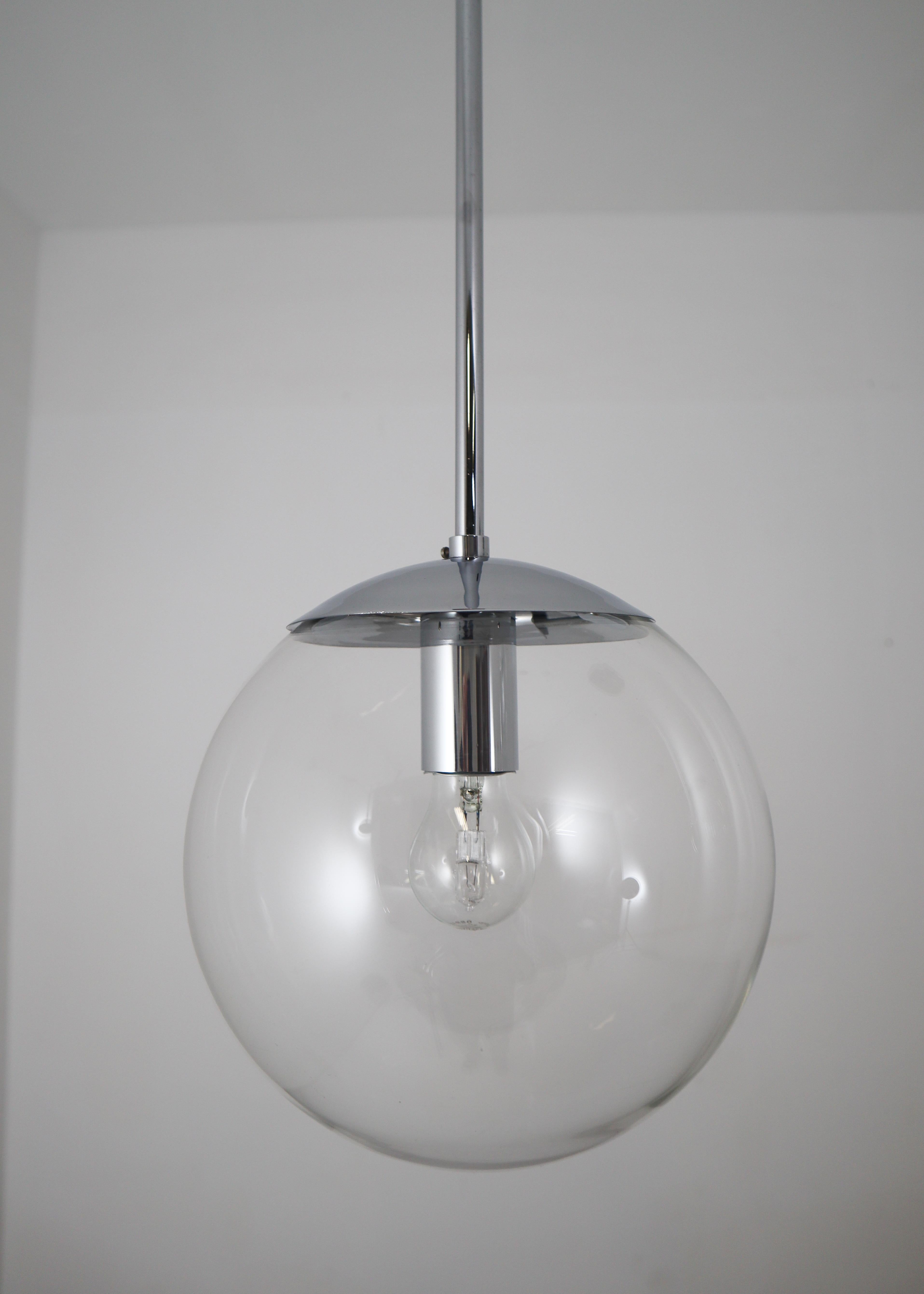 Hand blown pendant lamps were made by the German manufacturer Limburg Glashütte in the 1970s. The hand blown glass globes are mounted on a chrome base. Heavy quality and in very good condition. The pleasant light spreads very atmospheric, this