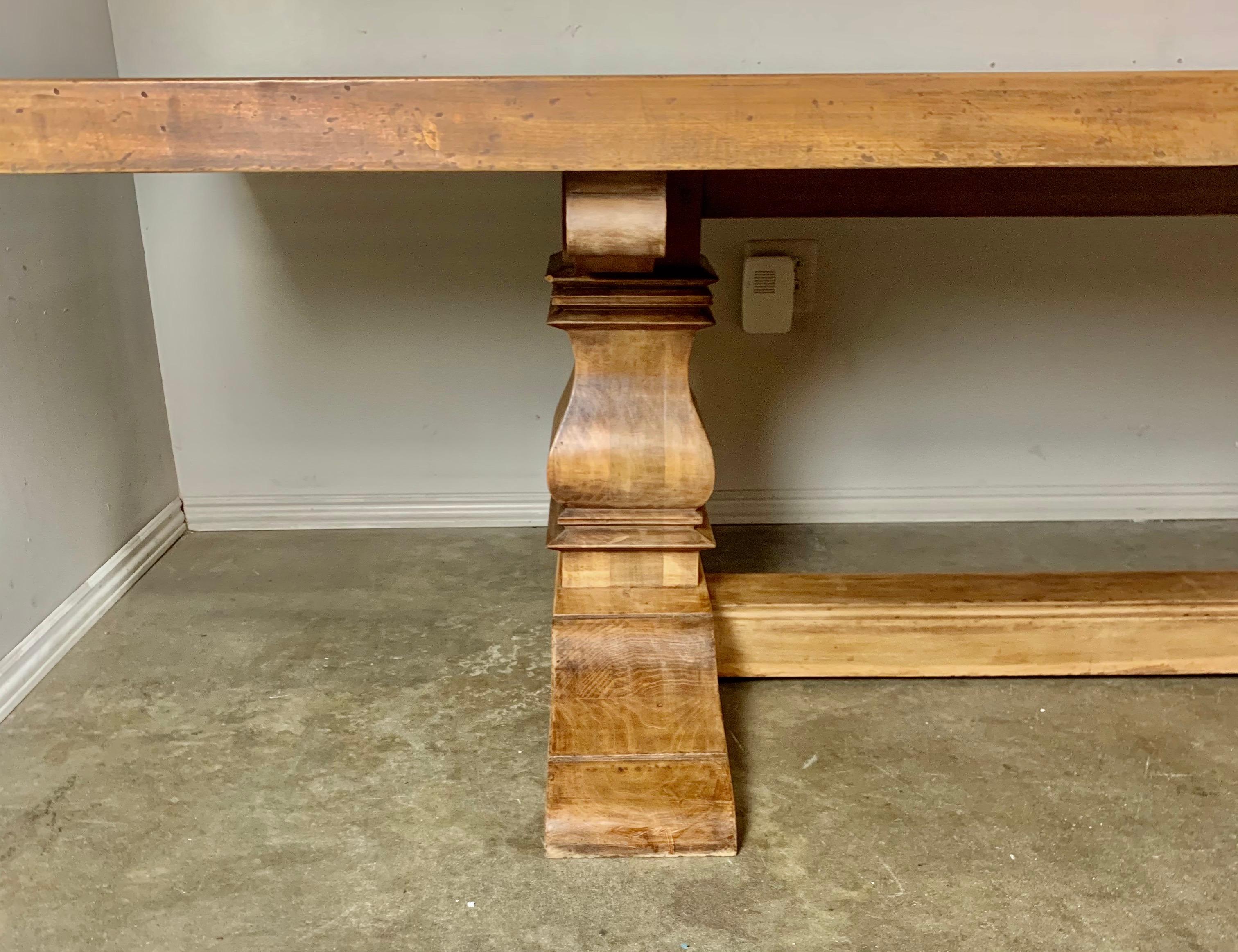 Italian midcentury walnut Italian trestle dining table. A large rectangular top sits on a pair of pedestal bases connected by a center stretcher. Beautiful natural walnut finish. Measure: 10'.