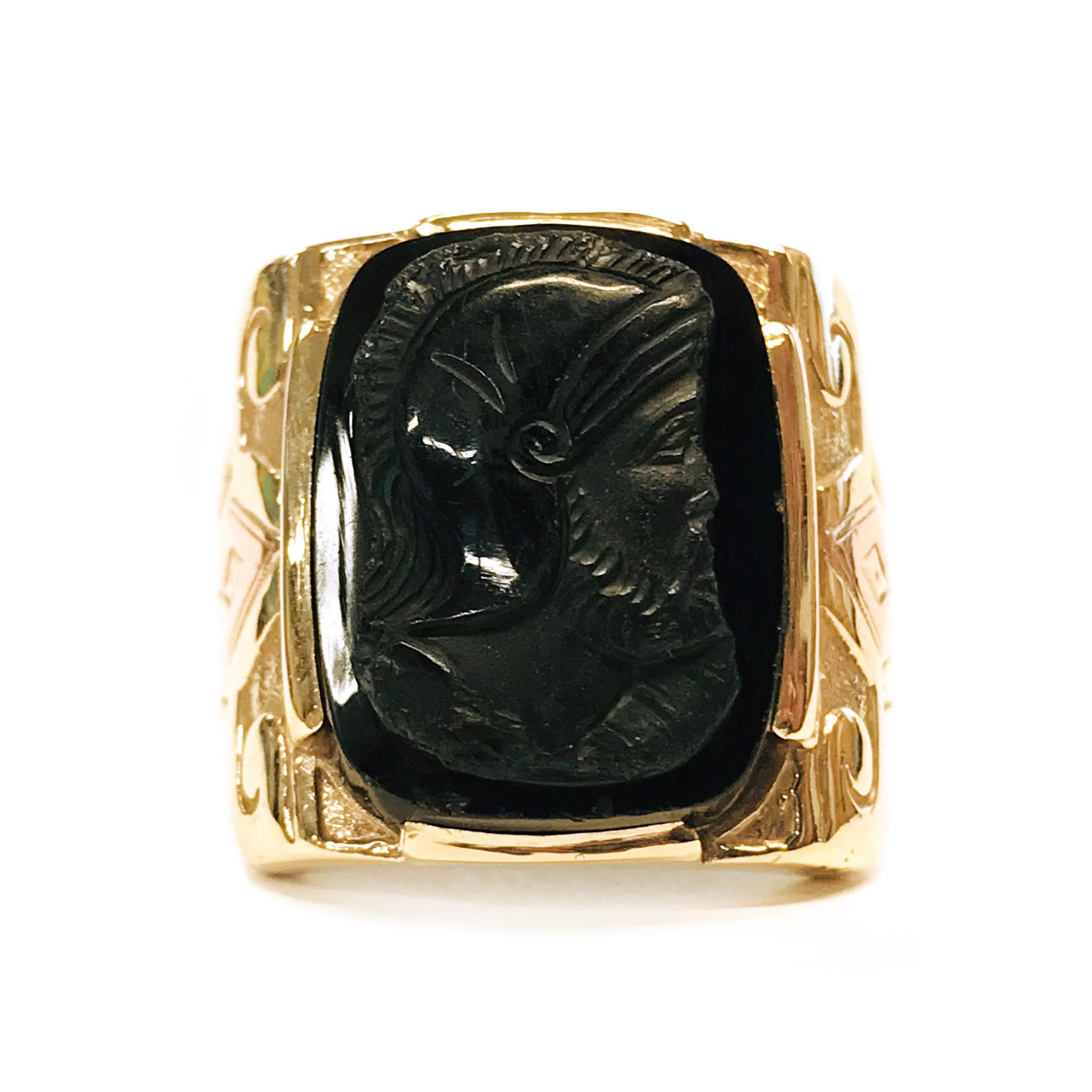 10 Karat Art Deco Intaglio Ring. The wideband has an Art Deco motif and the band tapers. The center of the ring is 19.5mm x 14.7mm Onyx Intaglio of a Roman soldier. Stamped on the inside of the band is 10K. The ring size is 9 3/4. The total gold