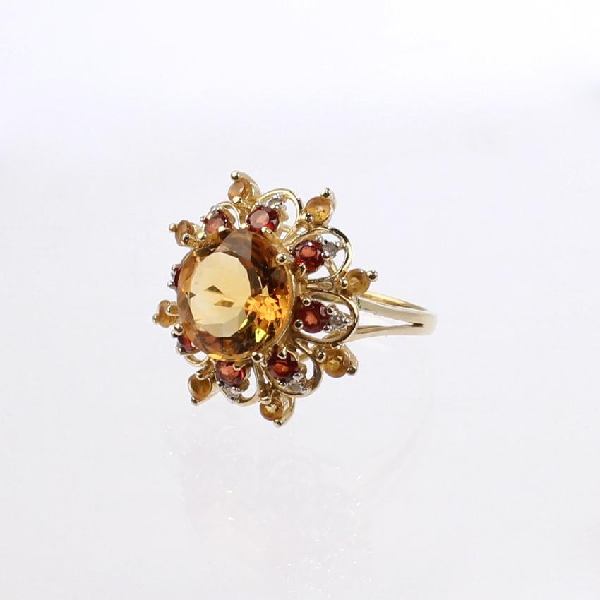 A very fine 10k citrine and diamond starburst cluster cocktail ring.

With varied shades of orange round faceted citrine and diamonds prong set in 10k gold.

An eye-catching ring!

Date:
20th Century

Overall Condition:
It is in overall good,