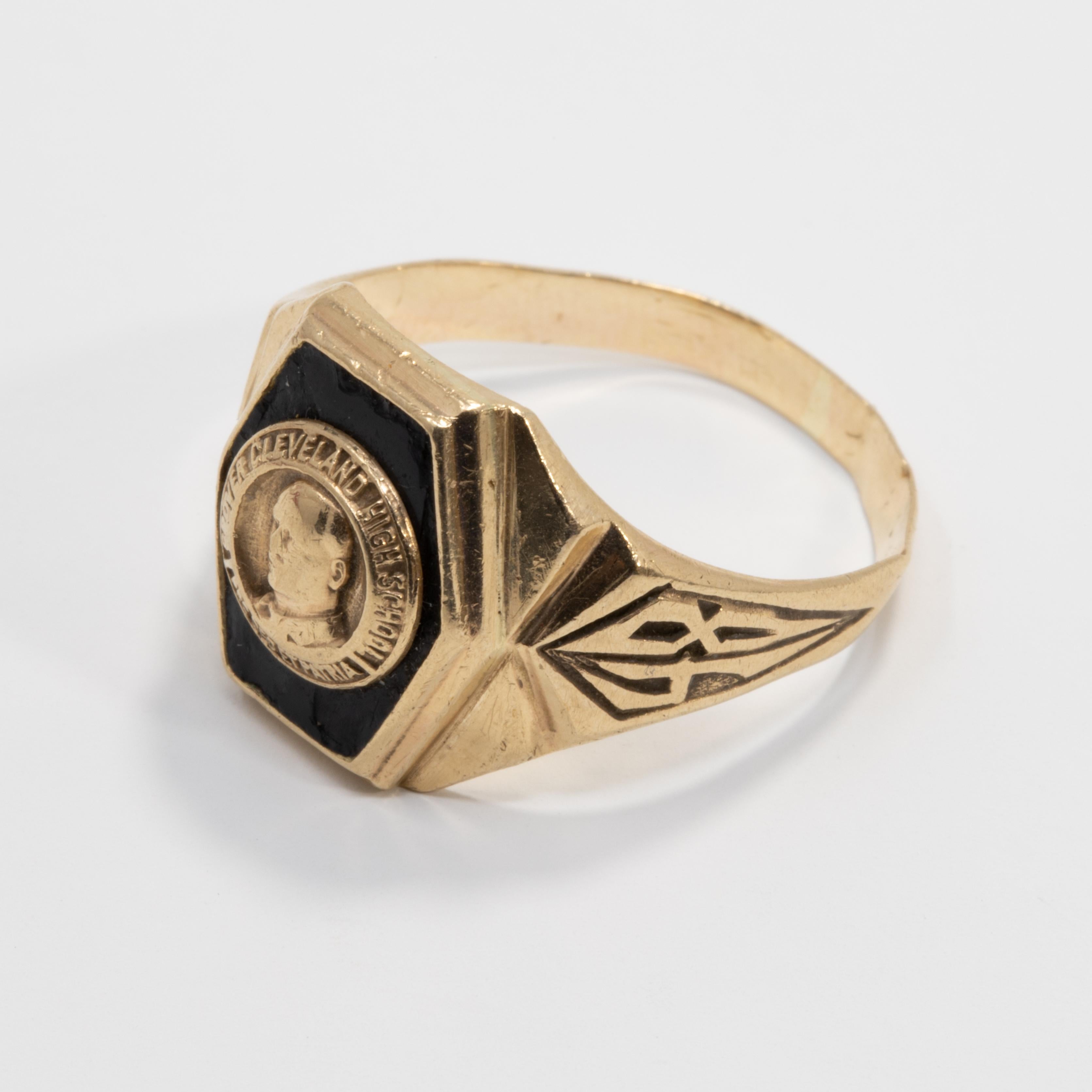 A classy 10K gold 1948 class ring with onyx inlay. The face features a motif of a man and inscribed 