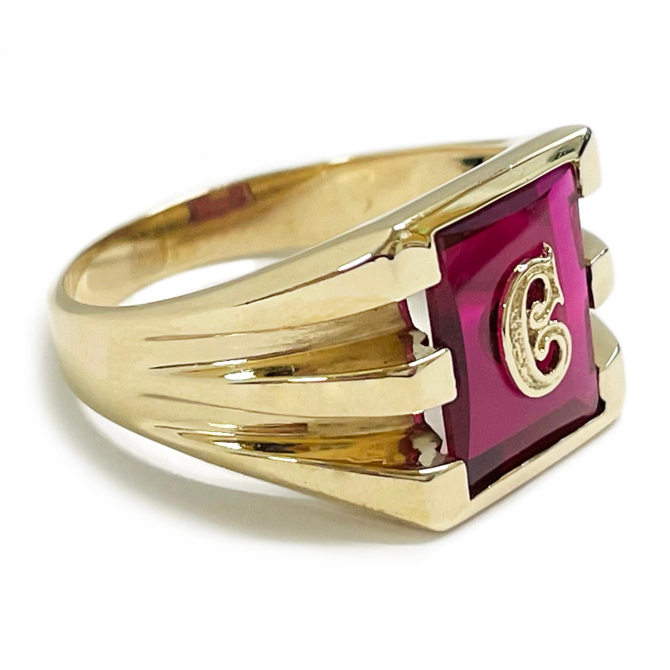 10 Karat Pink Corundum Initial C Ring. At the center of the ring is a 10 x 12mm pink Corundum with a gold ornate initial C set in the stone. There is a small piece of stone missing inside the bottom of the open space of the C (see photos), however